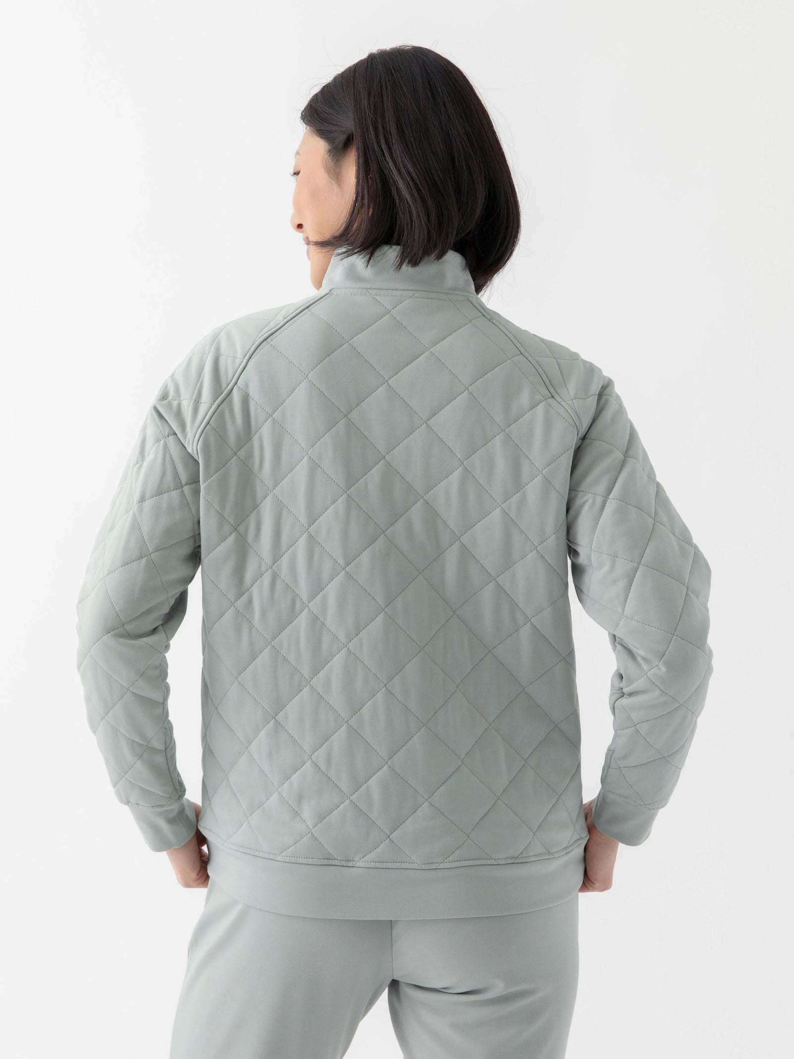 Woman wearing a white Cozy Earth Brushed Bamboo Quilted Pullover against a white background