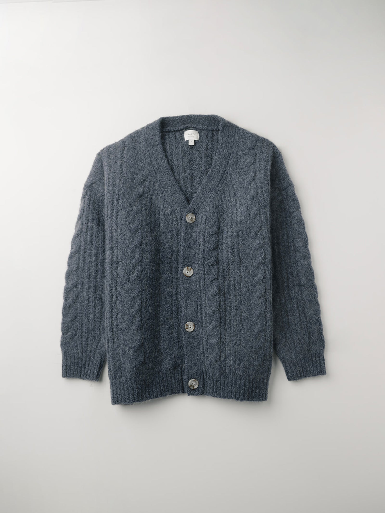 Flat lay of indigo cardigan with white background