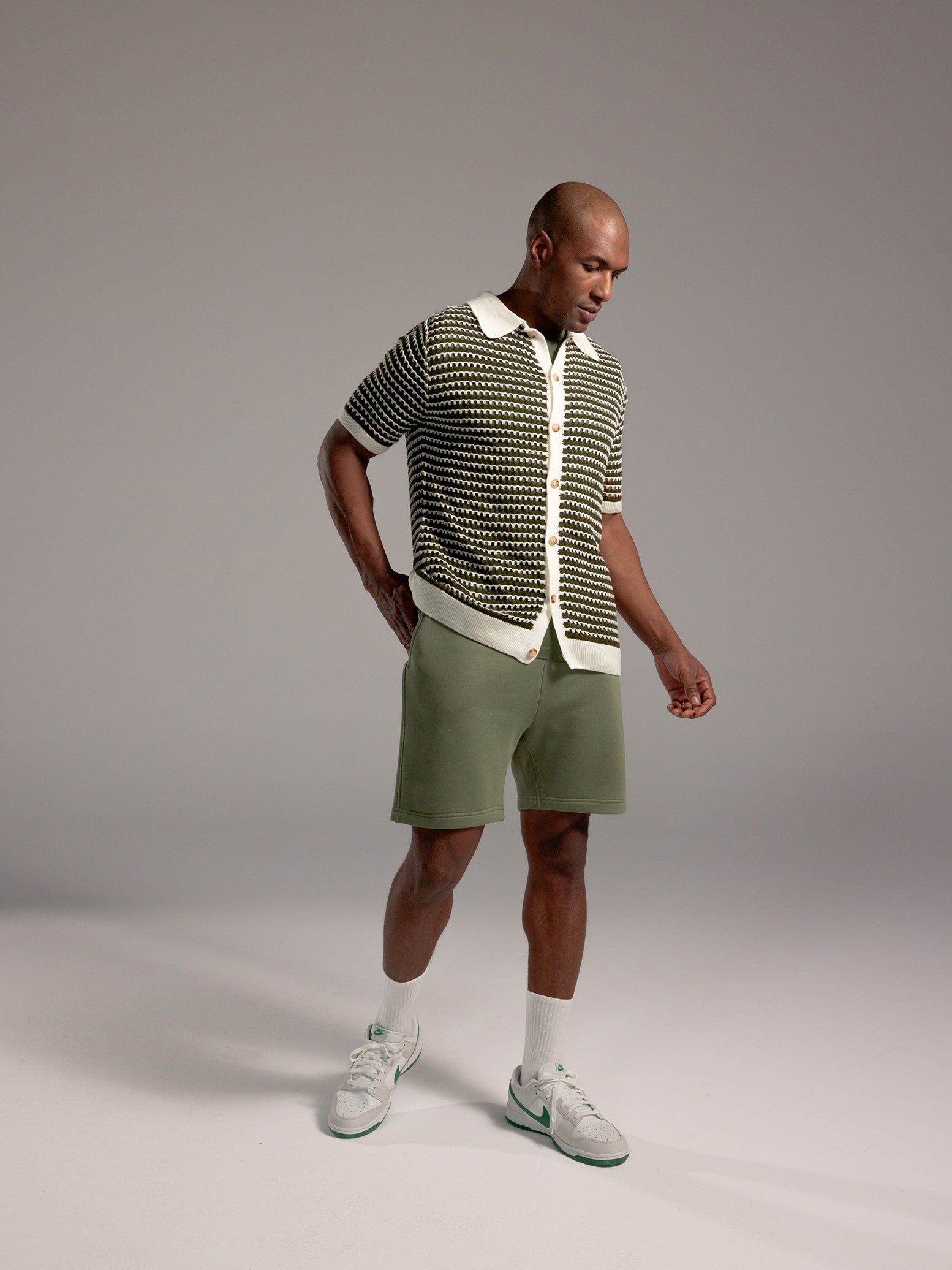 Man wearing Juniper CityScape Shorts with grey background