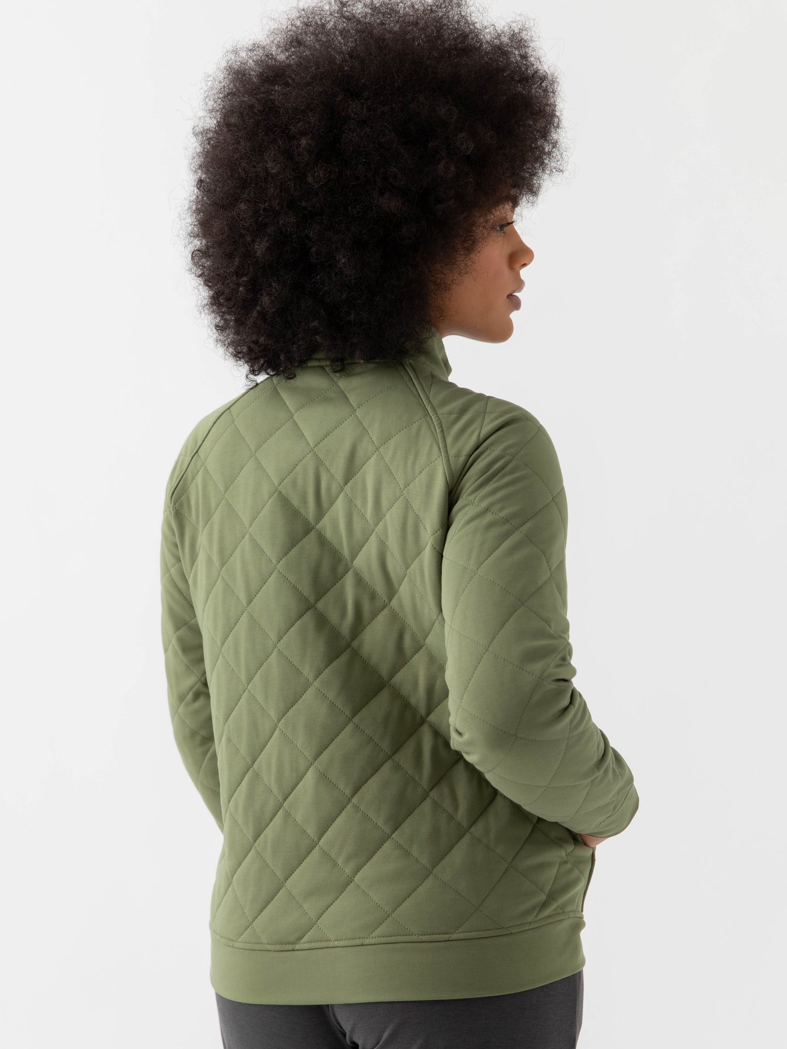 Woman wearing a green Cozy Earth Brushed Bamboo Quilted Pullover against a white background