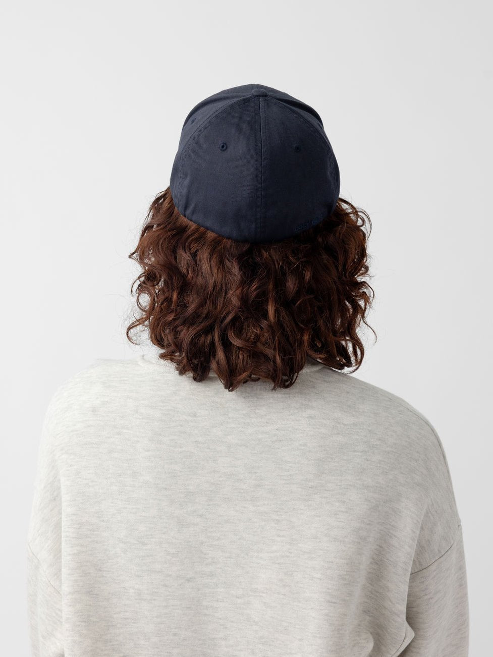 Back of woman wearing navy urban classic hat