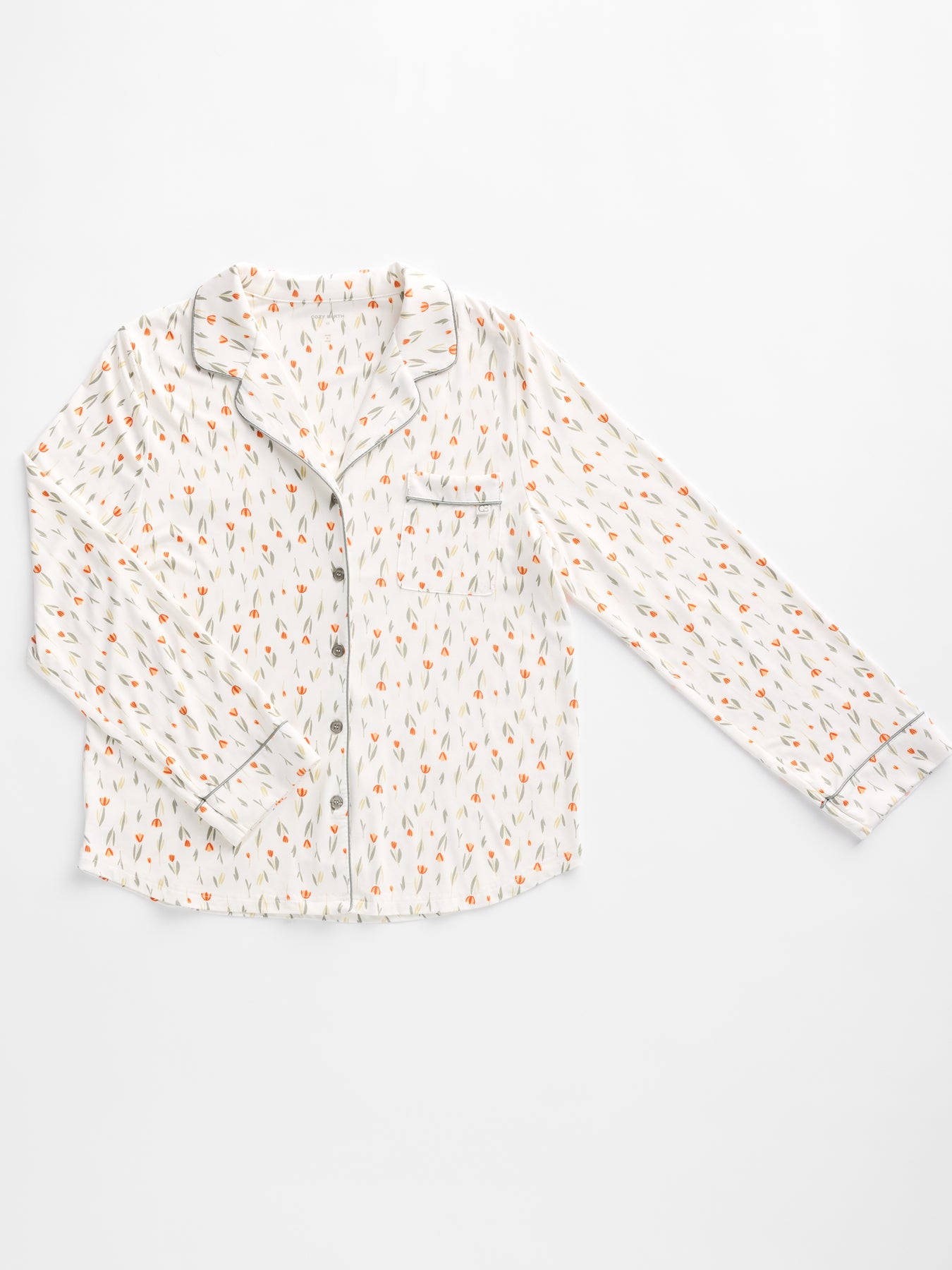 The Women's Bamboo Stretch-Knit Long Sleeve Pajama Top by Cozy Earth features a small carrot pattern with a notched collar, left-side front pocket, and buttons down the front.