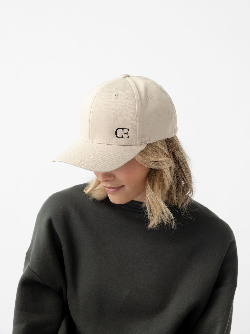 Woman wearing stone urban classic hat looking down 