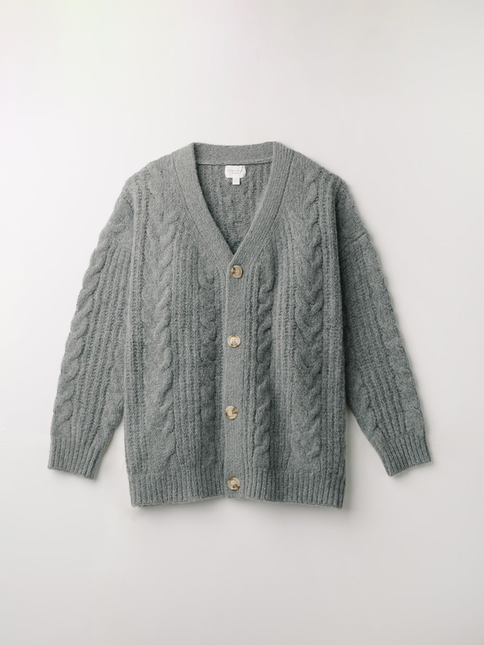 Flat lay of thyme cable knit cardigan with white background