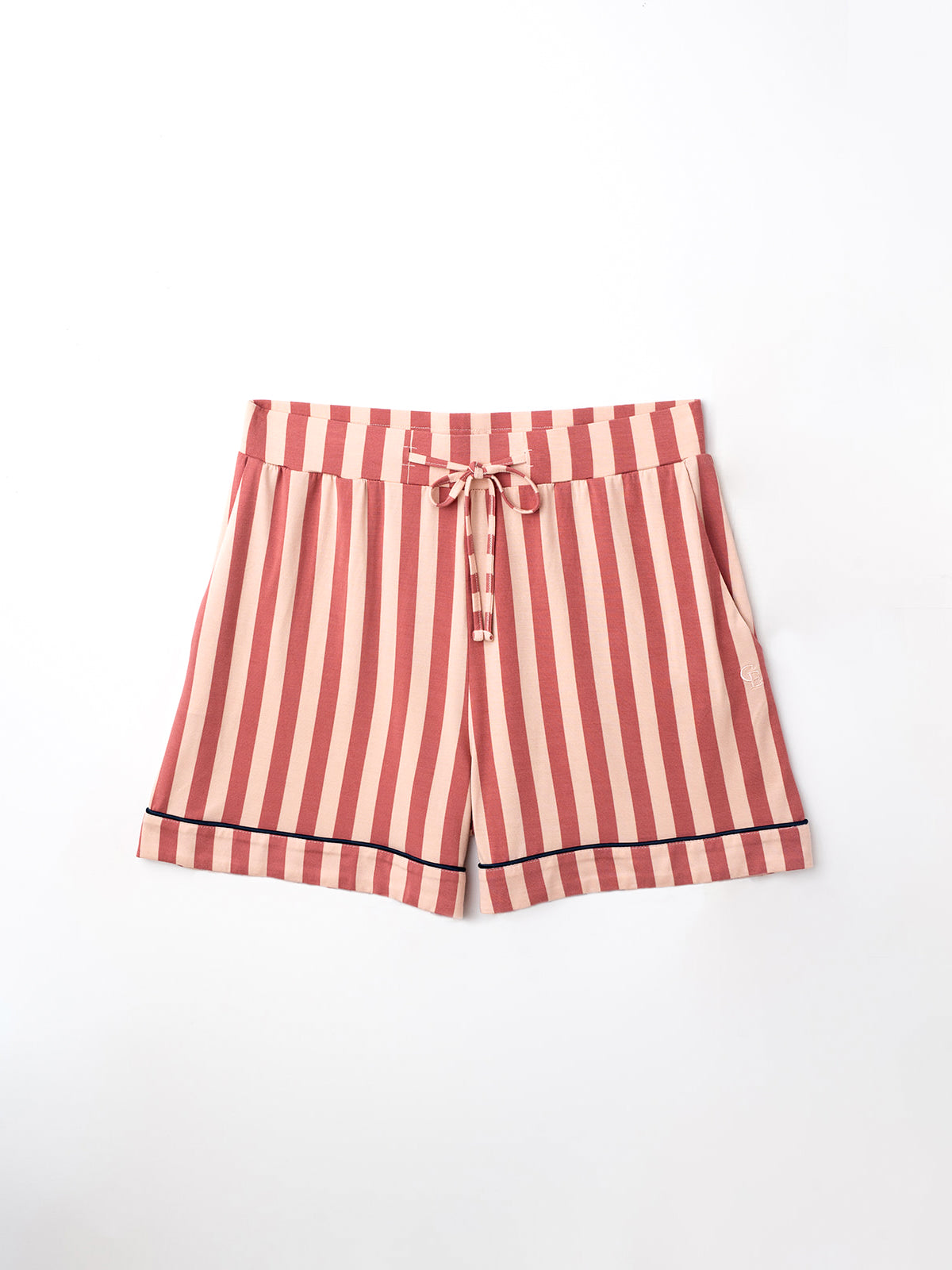 Flat lay of blush stripe pajama shorts with white background