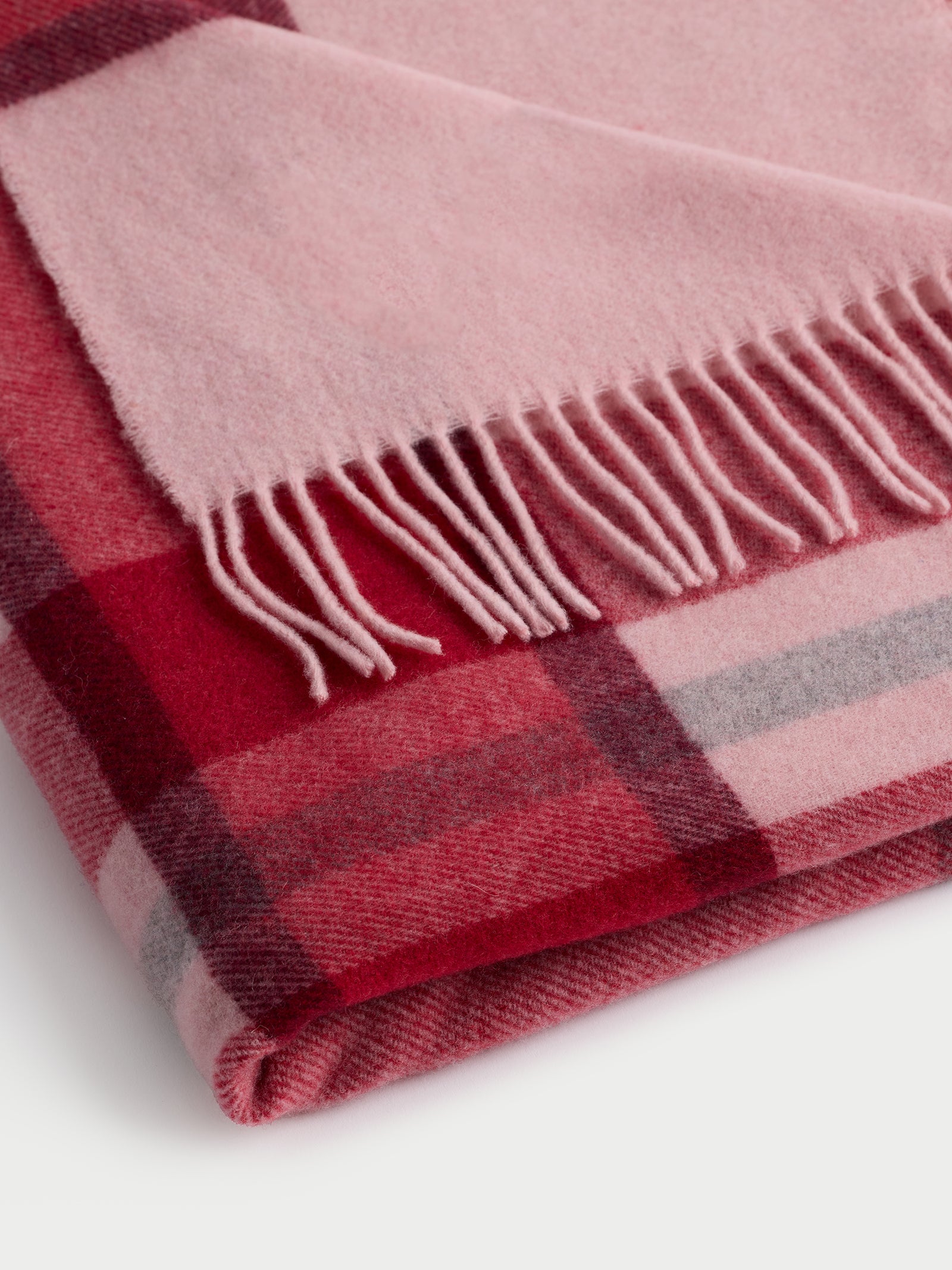 Close up of folded pink lucca throw