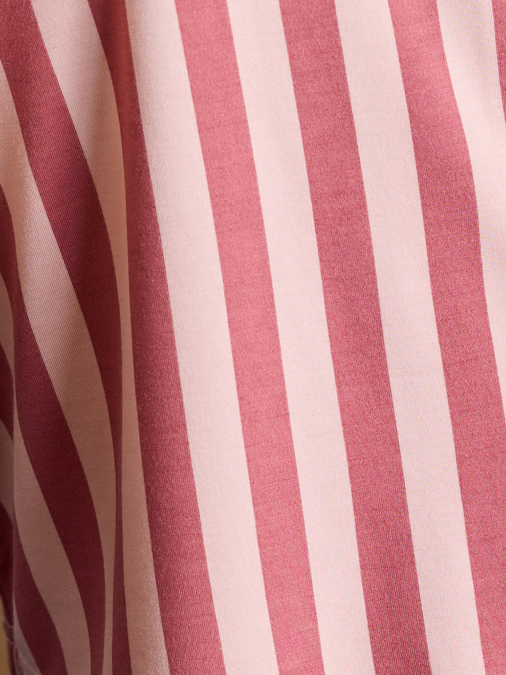 Close up of blush stripe pajama pattern