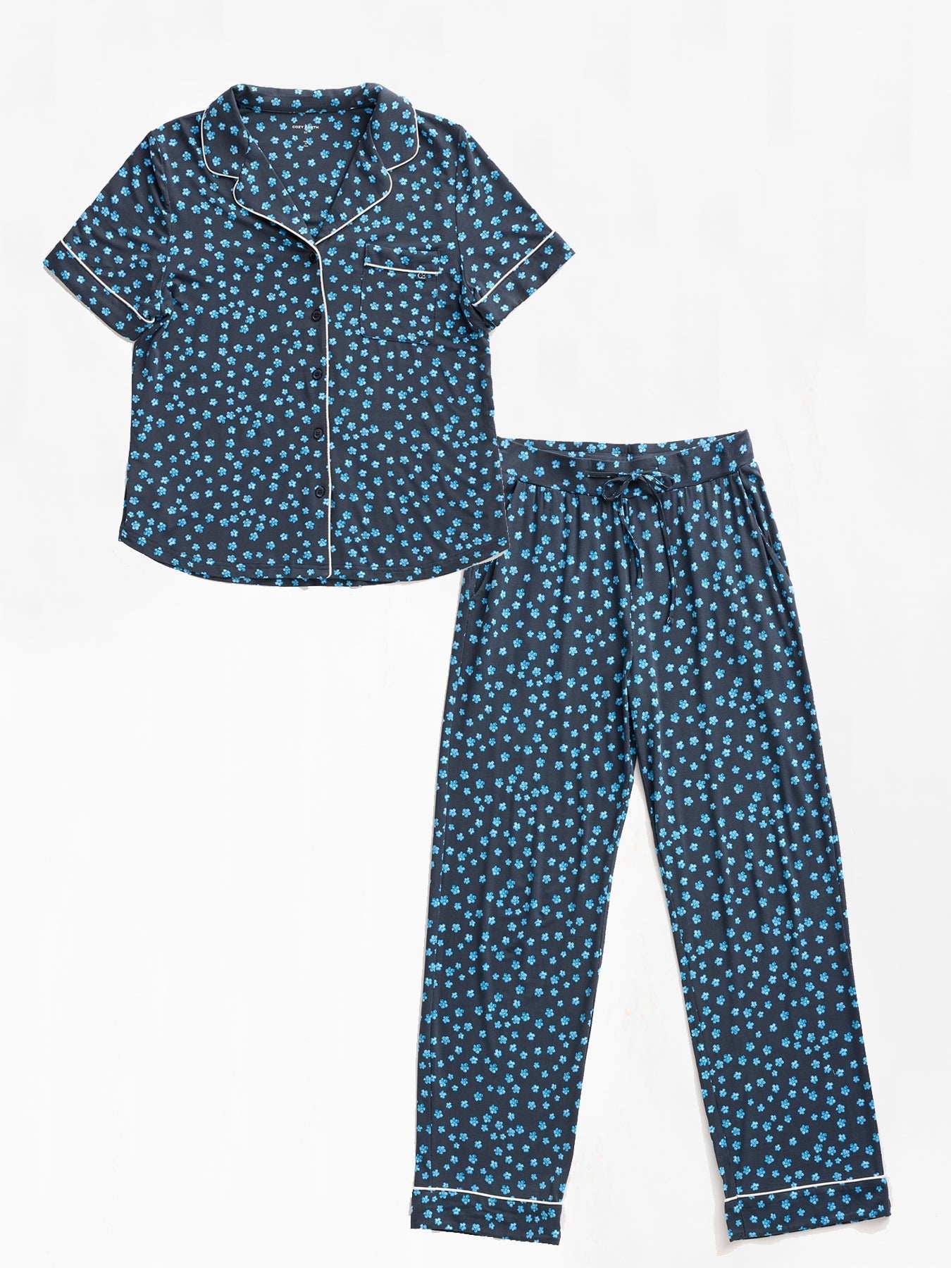 Cozy Earth's Women's Bamboo Stretch-Knit Short Sleeve & Pant Pajama Set is a two-piece set with a collared, short-sleeved shirt and matching pants in dark blue with light blue polka dots, detailed with white piping.