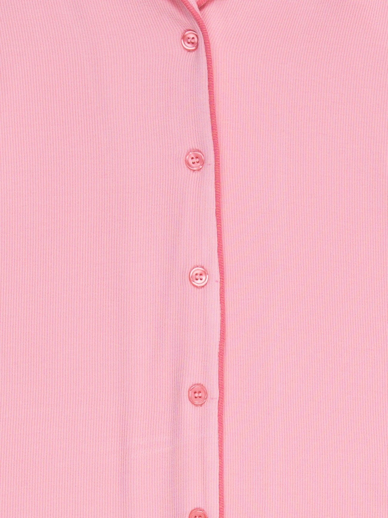 Close-up of Cozy Earth's Women's Bamboo Rib Knit Long Sleeve Pajama Top in pink, featuring a vertical row of matching buttons and a subtle ribbed fabric texture.