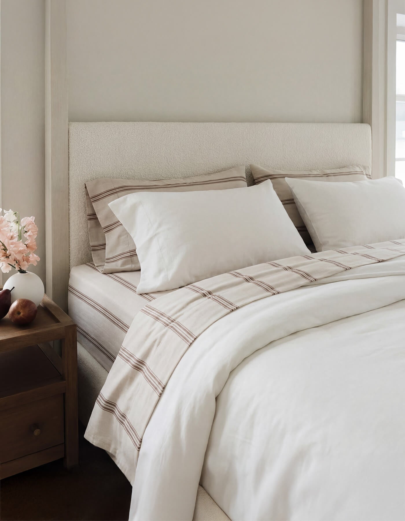 A bed featuring Cozy Earth Bamboo Sheets in Baja Stripe in Maple |Color:Baja Stripe in Maple
