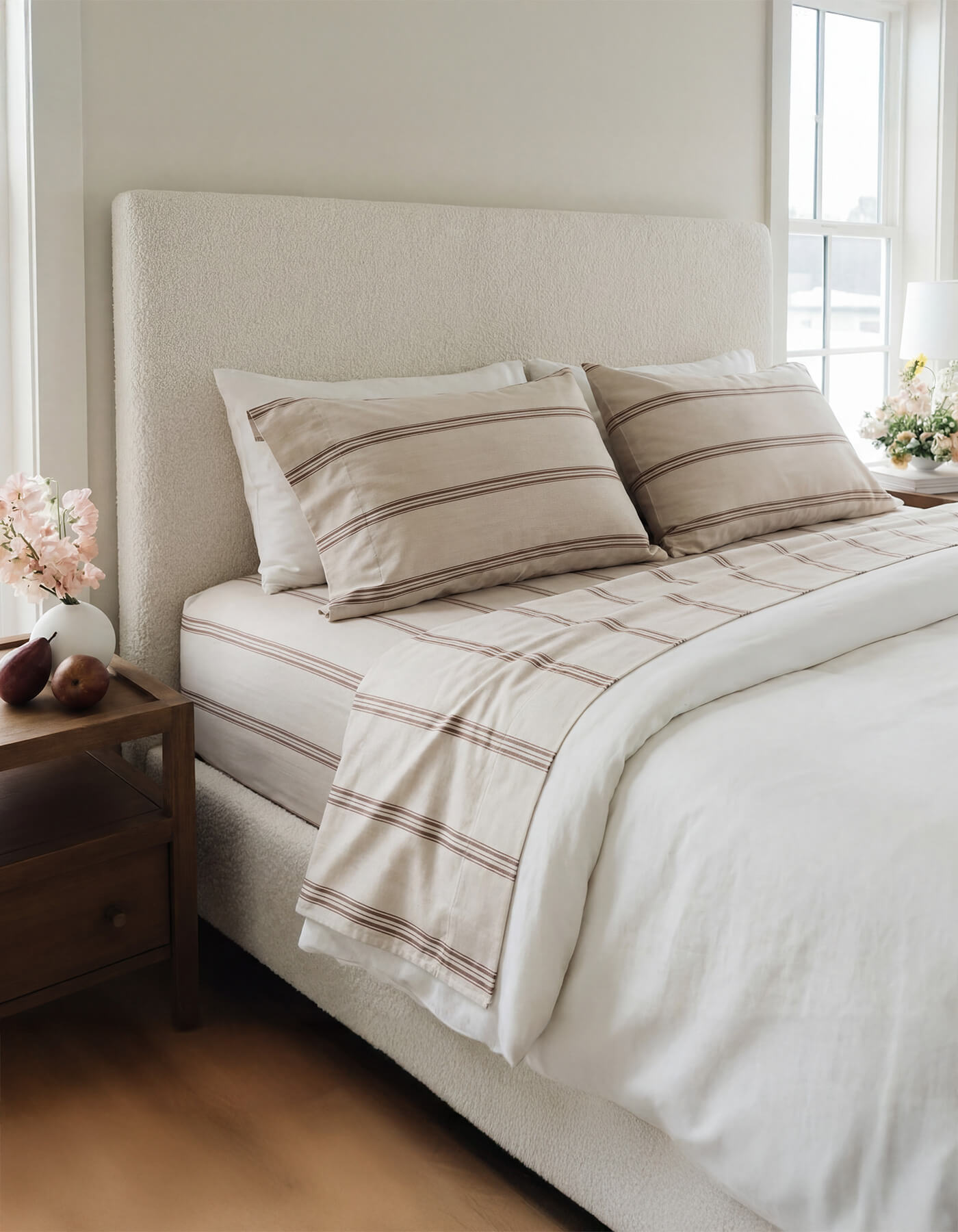 A bed featuring Cozy Earth Bamboo Sheets in Baja Stripe in Maple |Color:Baja Stripe in Maple