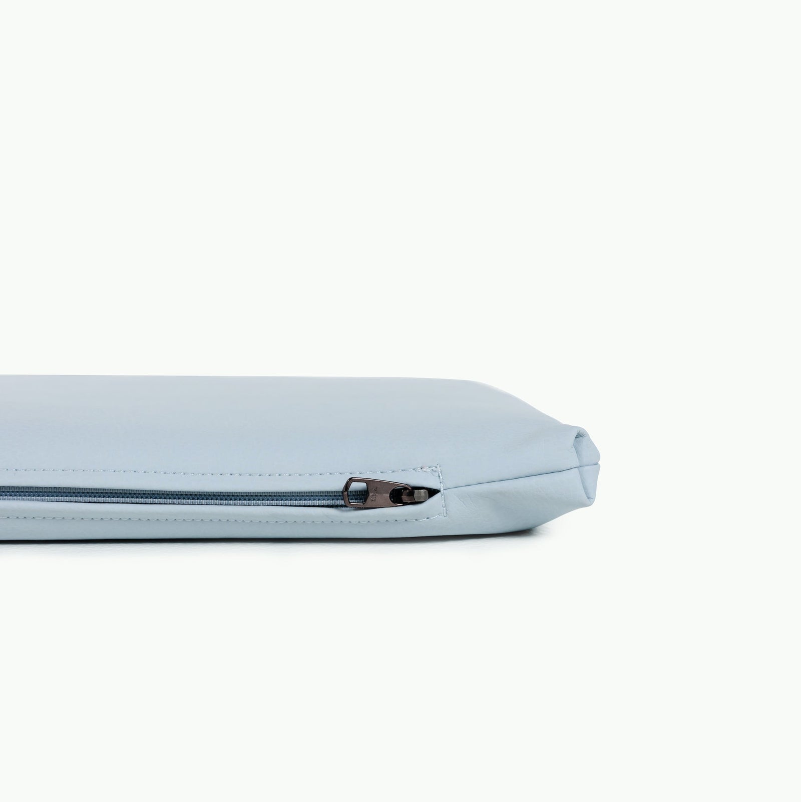 A close-up of the Gathre Wholesale Padded Changing Mat in light blue, shown lying flat with its zipper partially visible against a plain white background.