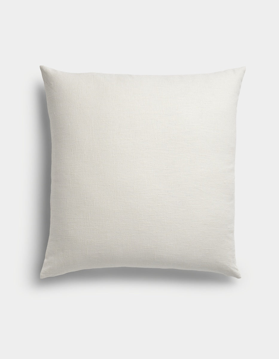 The Sonoma Throw Pillow by Cozy Earth, featuring a square shape and smooth, plain white fabric, is displayed against a light background in an overhead shot.|Color:Sea Salt|Size:26" x 26"