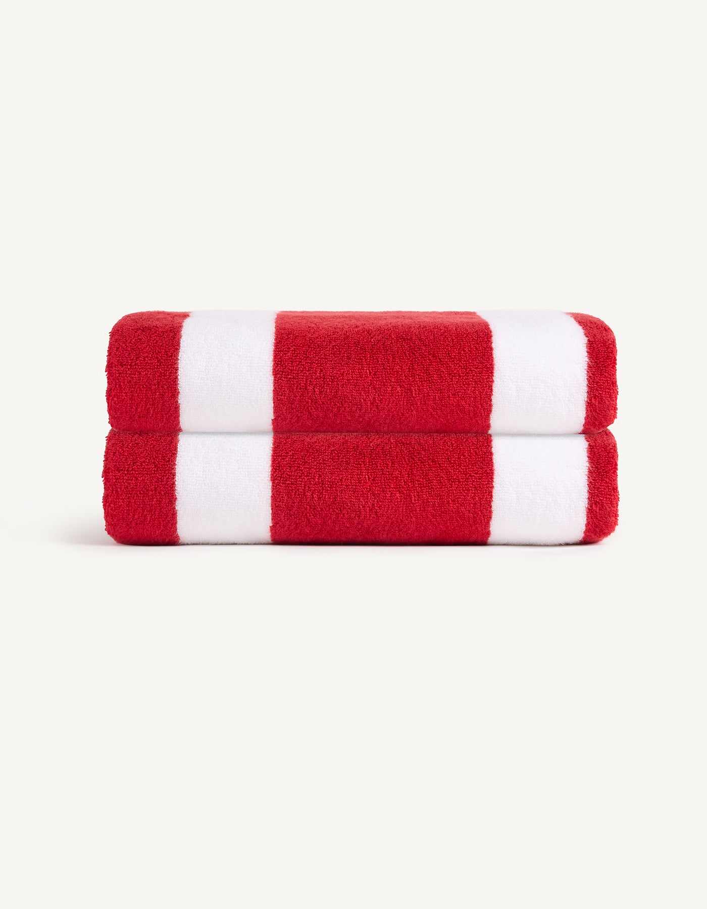 The Classic Stripe Resort Towel Bundle by Cozy Earth features neatly folded towels with bold red and white stripes, stacked on a light background. |Color:Crimson