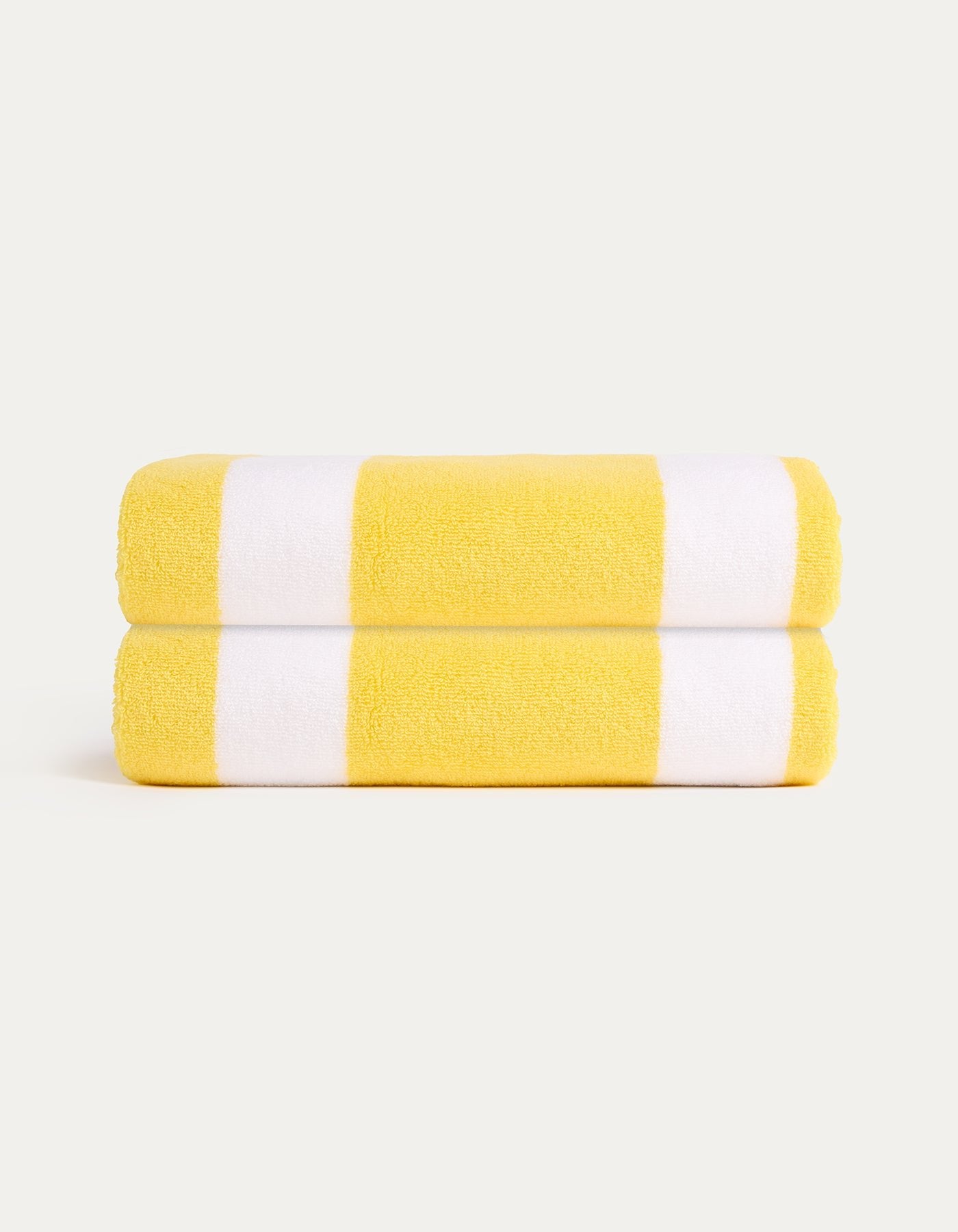 The Cozy Earth Classic Stripe Resort Towel Bundle features two neatly folded towels with bold yellow and white stripes, stacked together against a simple light background.|Color:Lemon