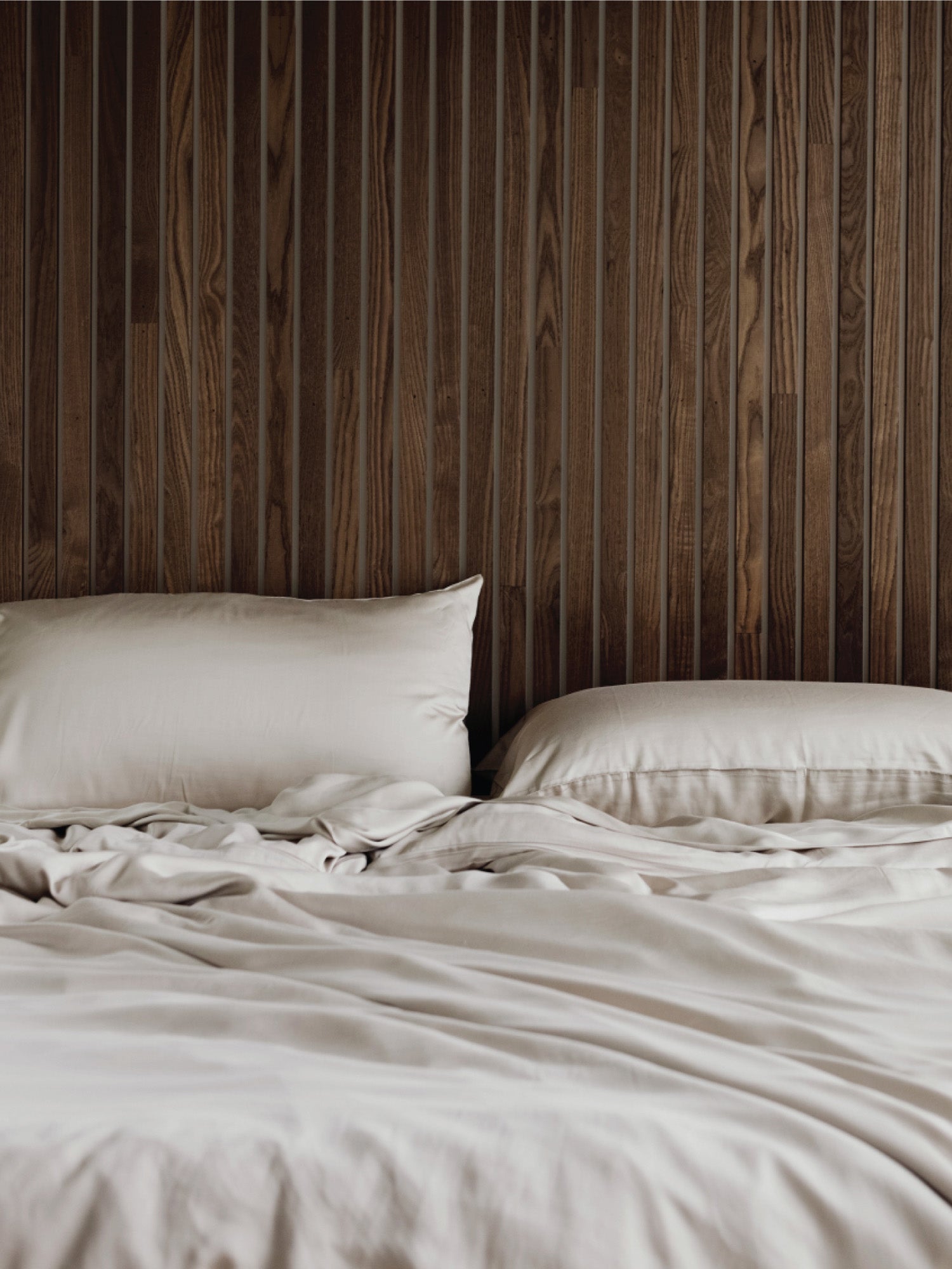 Driftwood pillows and duvet cover on an unmade bed
