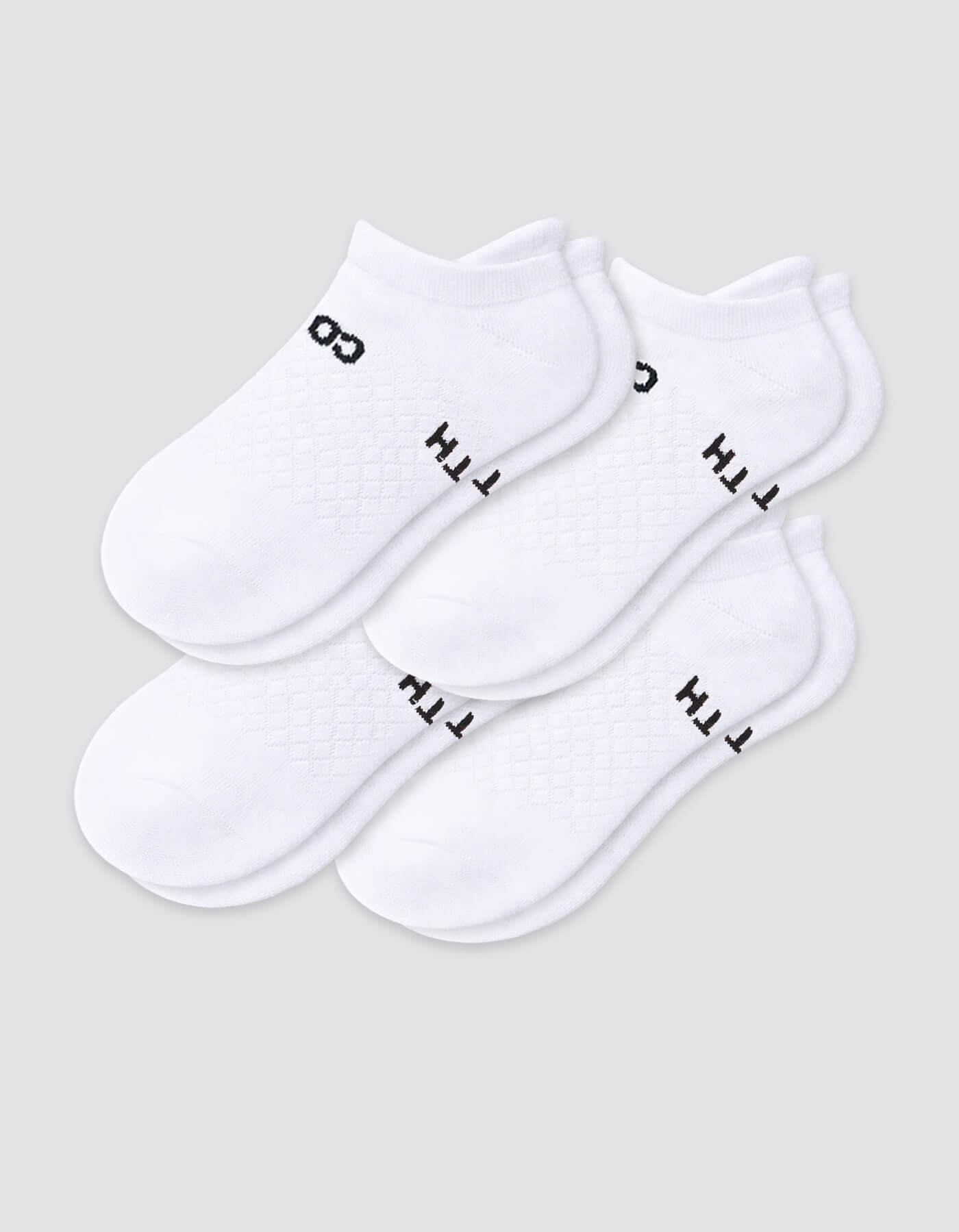 The Cozy Earth Women's Essential Ankle Sock 4-Pack features white ankle socks with black text and designs near the ankles, shown on a light gray background.|Color:White
