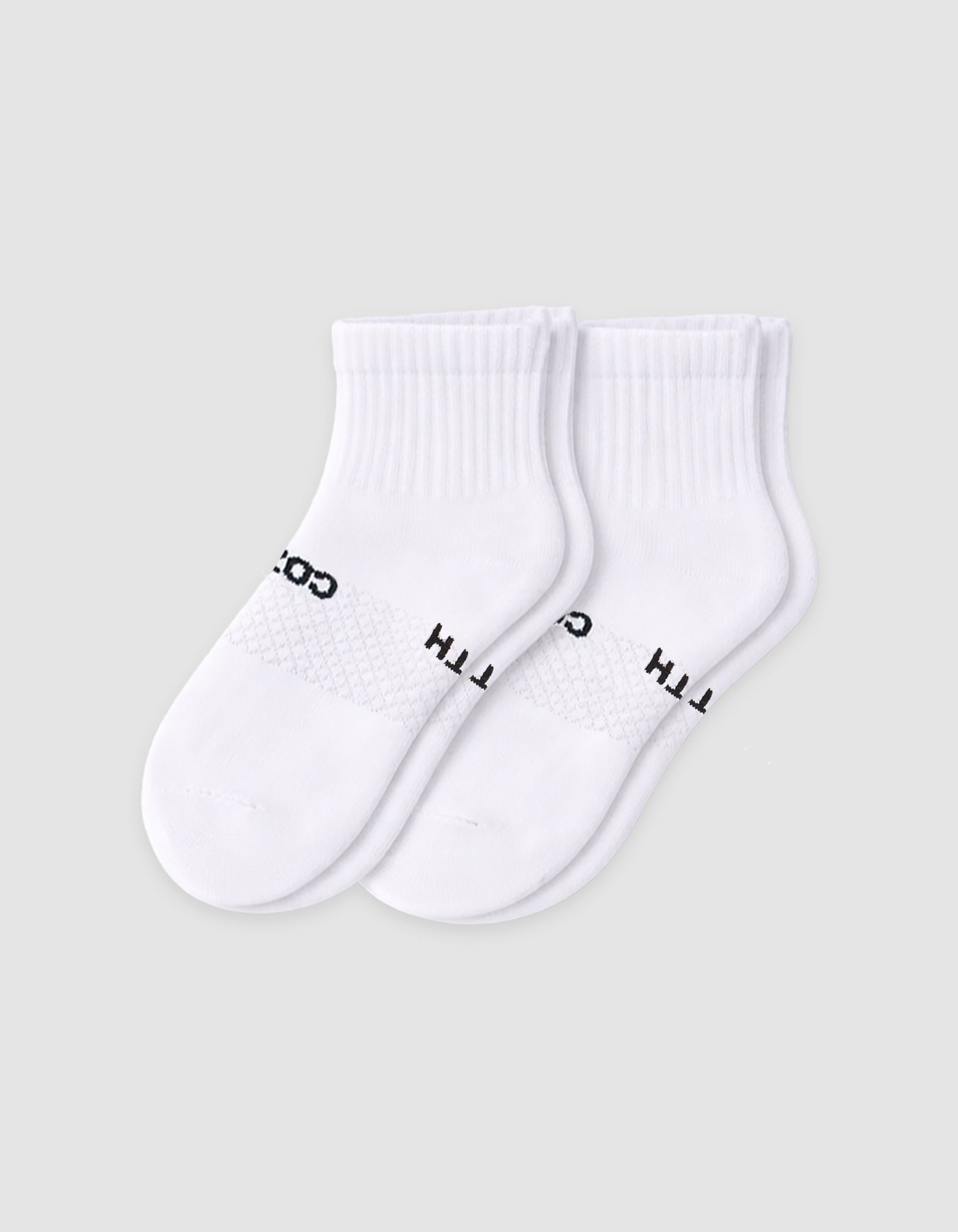 The Cozy Earth Men's Essential Quarter Sock features white ribbed cuffs and a discreet black text design on the sides, displayed against a plain light background.|Color:White