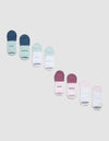 A Cozy Earth Essential Ankle Sock 4-Pack is shown in shades of blue, green, white, pink, and purple on a light gray background. Some socks have "COZY" or "EARTH" printed near the toes. |Color:Arctic/Lilac