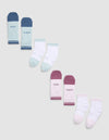 Four pairs of Essential Quarter Socks by Cozy Earth in pastel colors are displayed in a zigzag pattern on a gray background, with words like "COZY" and "EARTH" printed near the cuffs. |Color:Arctic/Lilac