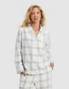 A woman with wavy blonde hair wears the Cozy Earth Women's Farmhouse Long Sleeve Pajama Top and matching pants, standing with her hands in her pockets against a plain, light background.|Color:Wintergreen Plaid