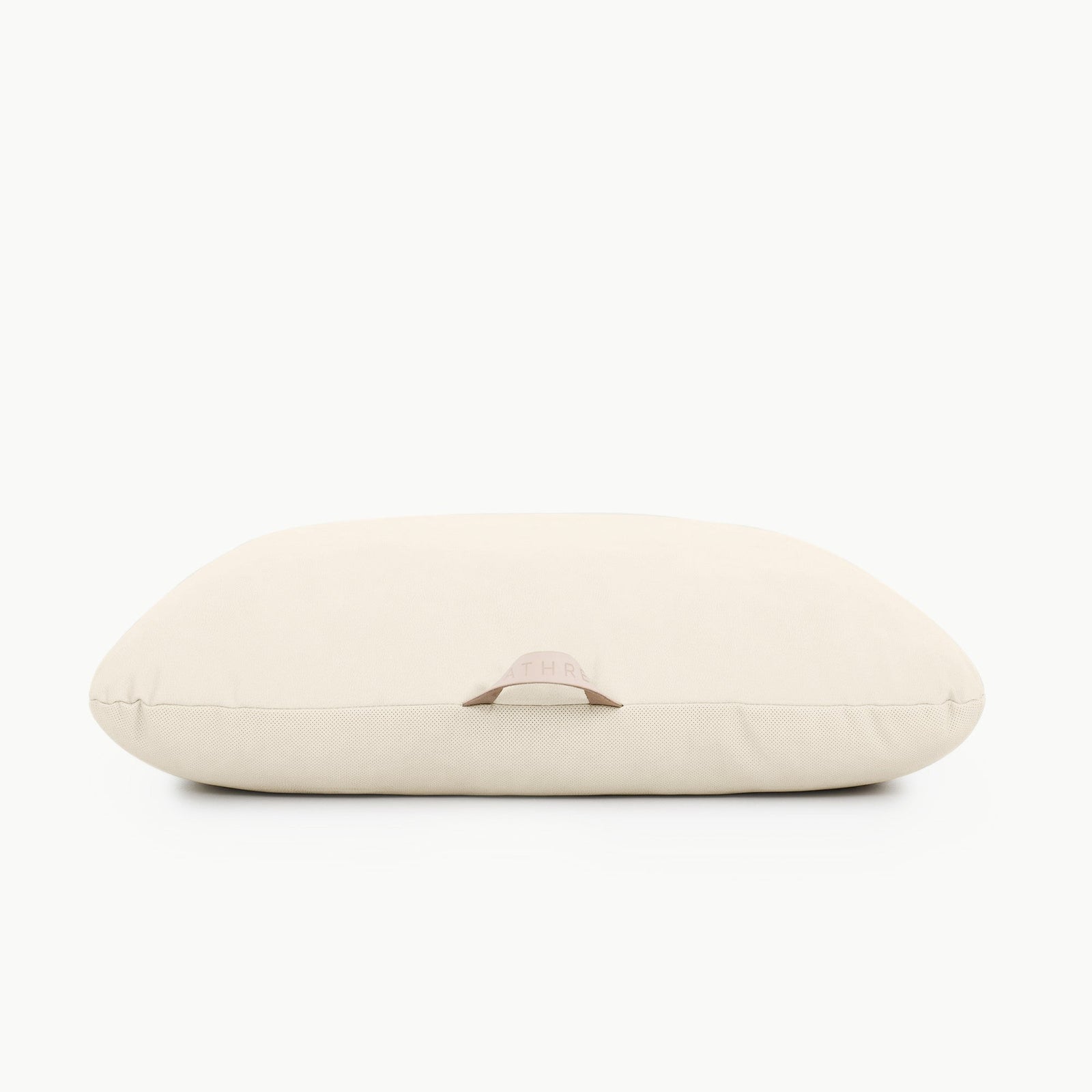 The Gathre Wholesale Floor Cushion is a rectangular, cream-colored pillow featuring a small fabric handle on the front, shown against a white background.