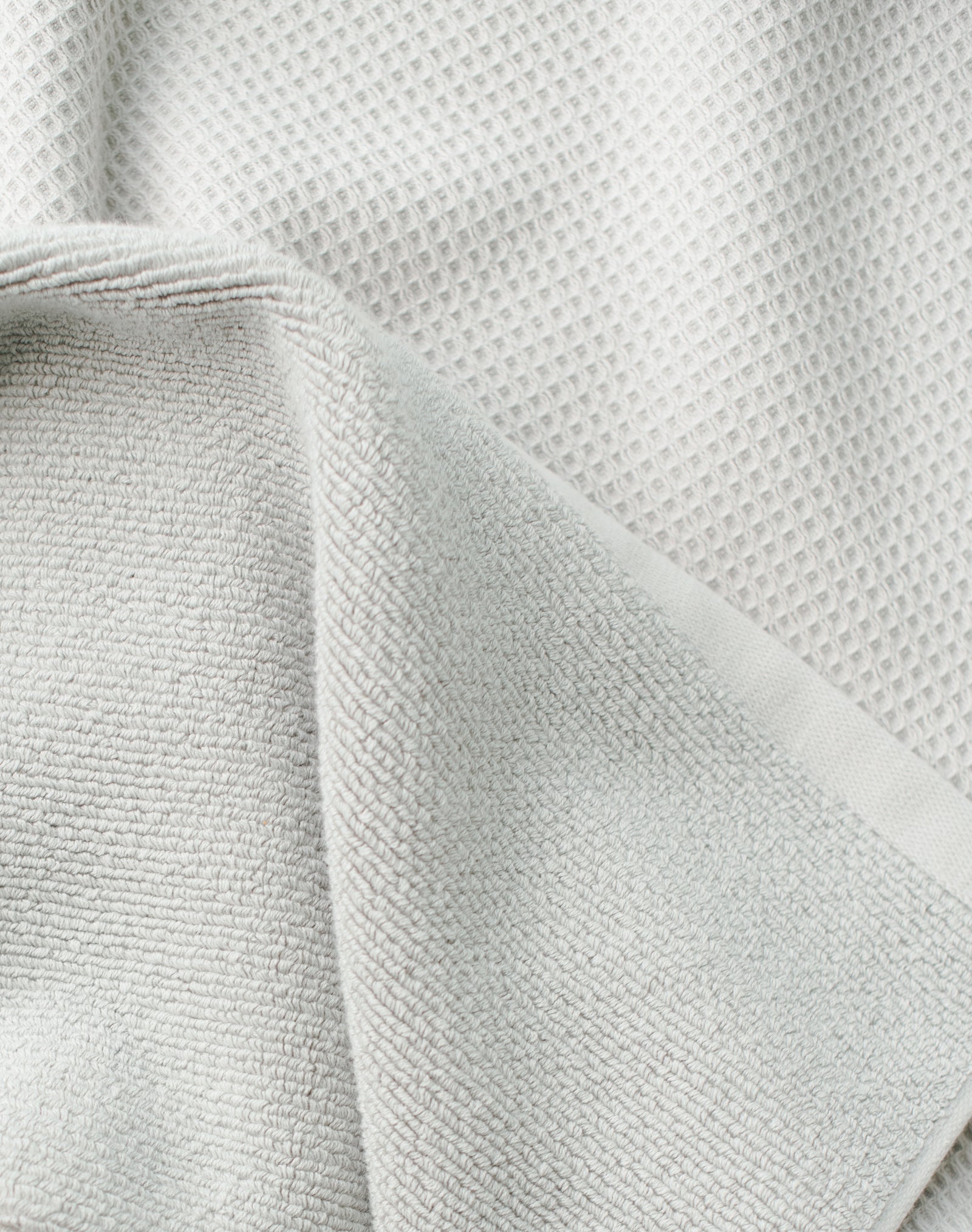 Waffle Bath Towel in the color Light Grey. Photo of Light Grey Waffle Bath Towel taken close up only showing the towel