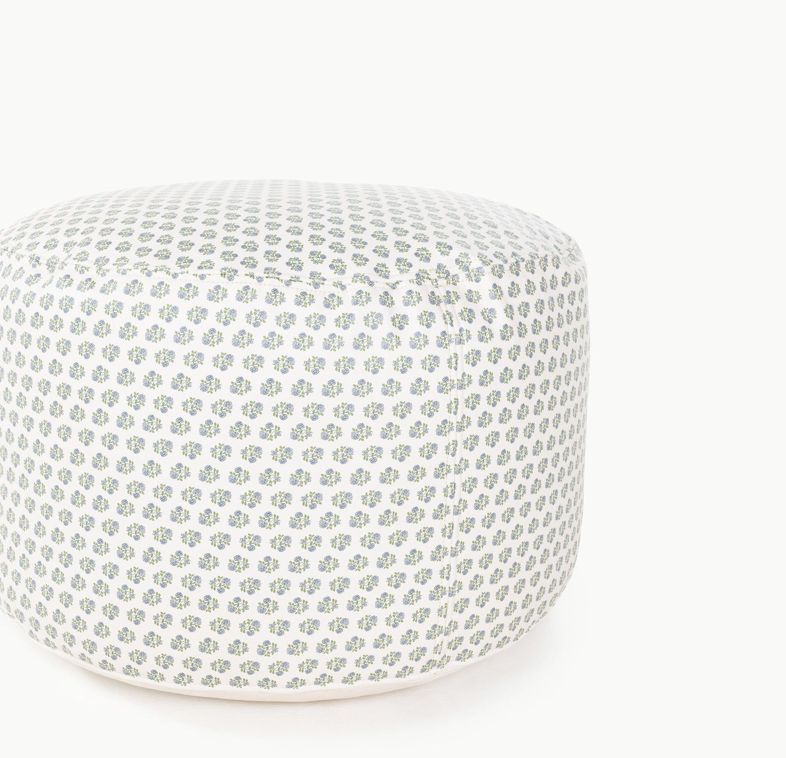 The Gathre Wholesale Pouf is a round ottoman featuring a repeating pattern of small green and blue floral designs on a white background, shown on a white surface.