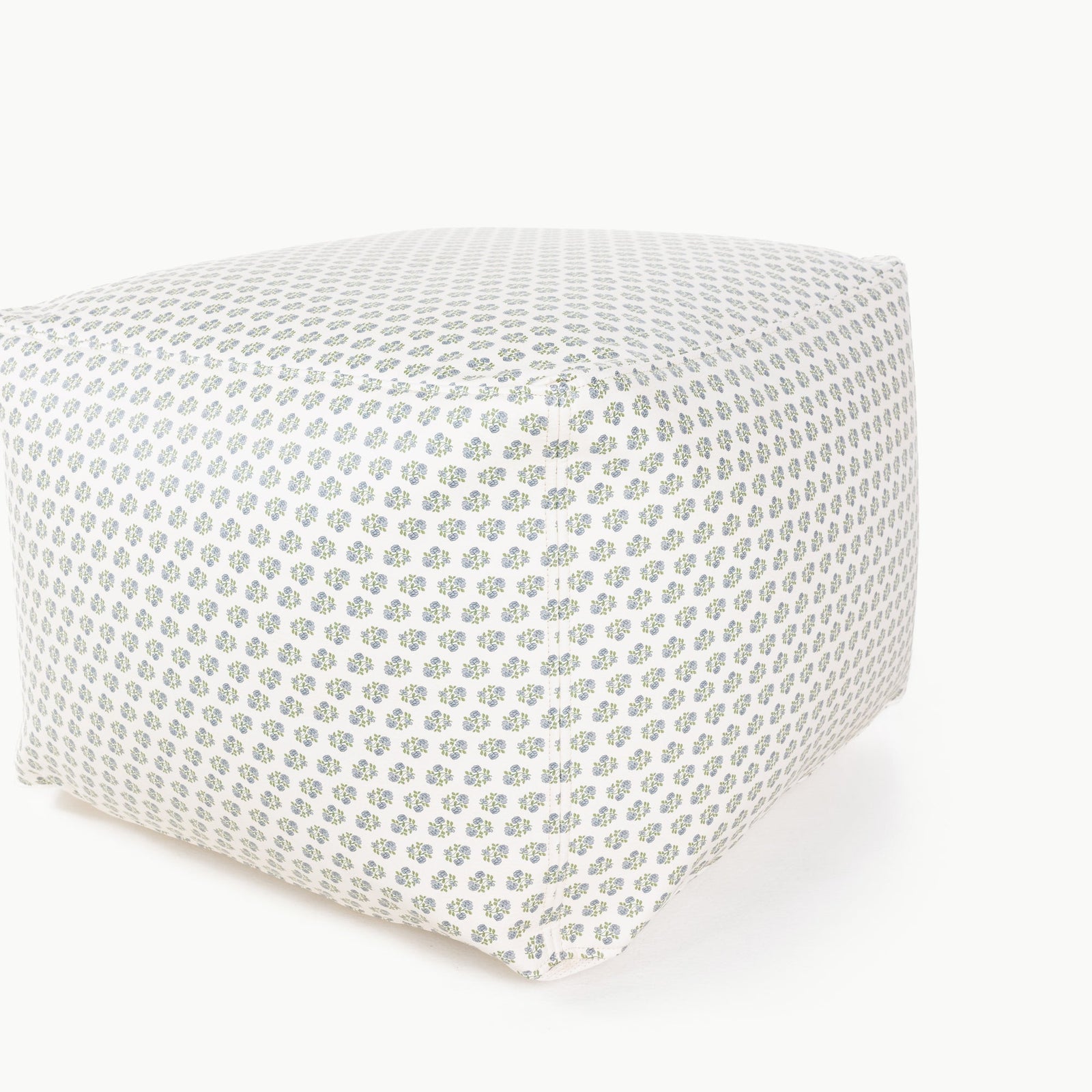 The Wholesale Pouf by Gathre features a square design with a green and blue floral pattern on a white fabric cover, shown against a plain white background.