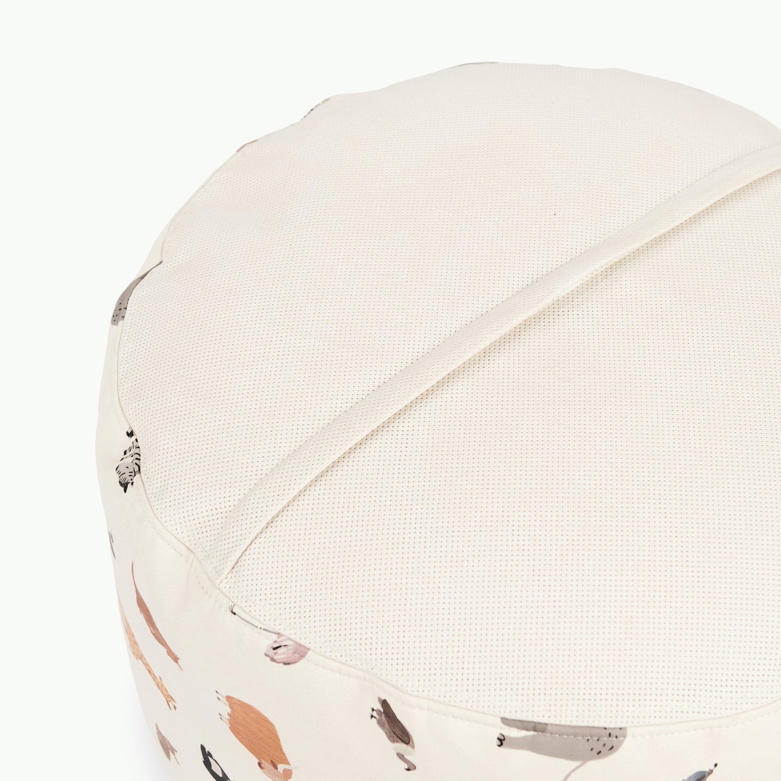 The Gathre Wholesale Pouf is a round, cream-colored ottoman featuring a removable top and subtle animal print sides, displayed against a white background.
