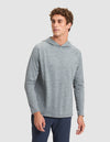 A man models the Cozy Earth Men's Lightweight Performance Hoodie in light gray with dark pants, standing against a plain light background and looking slightly left with a neutral expression. |Color:Heather Dawn