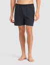A man stands barefoot against a plain background, wearing Cozy Earth Men's Performance Sleep Short with an elastic waistband. His upper body is not visible in the image. |Color:Jet Black