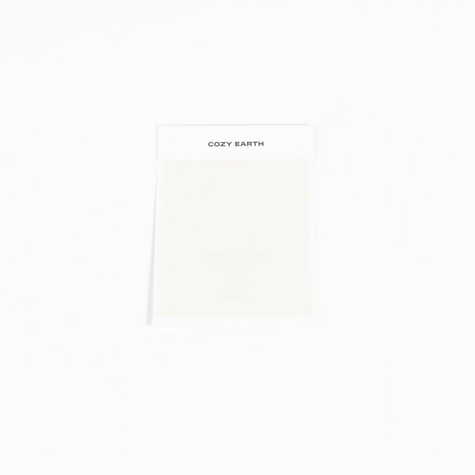 A compact rectangular package set against a white background features the "Cozy Earth" label at the top and appears to contain a light-colored item, specifically a Bamboo Sheet Swatch.