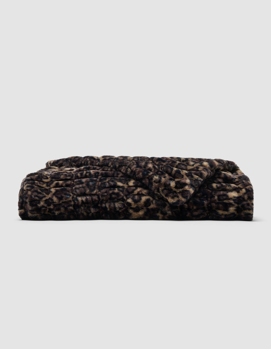 Folded Snuggle Cuddle Blanket in a brown and black leopard print pattern.|Color:Leopard in Sandalwood/Black