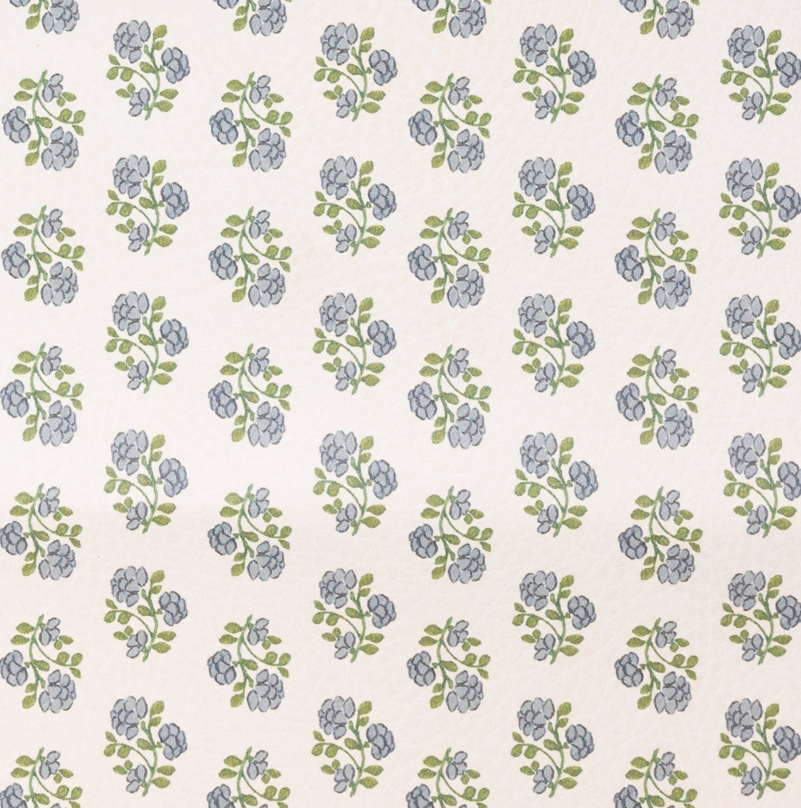 The Gathre Wholesale Pouf features a repeating pattern of small blue flowers with green leaves, arranged in evenly spaced rows on a light beige background.