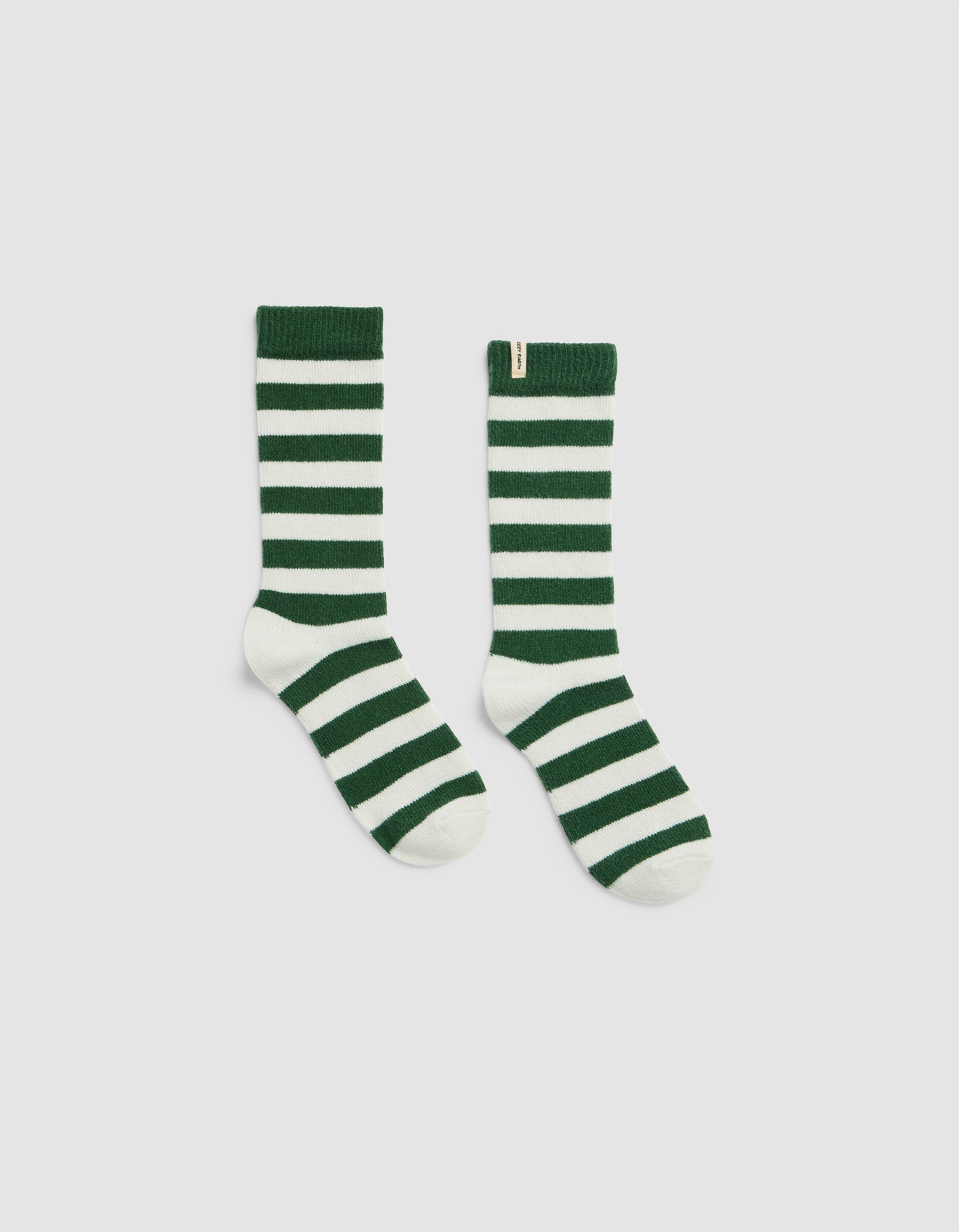 The Plush Modern Crew Sock by Cozy Earth features green and white stripes with solid green cuffs, heels, and toes, shown against a plain light background.