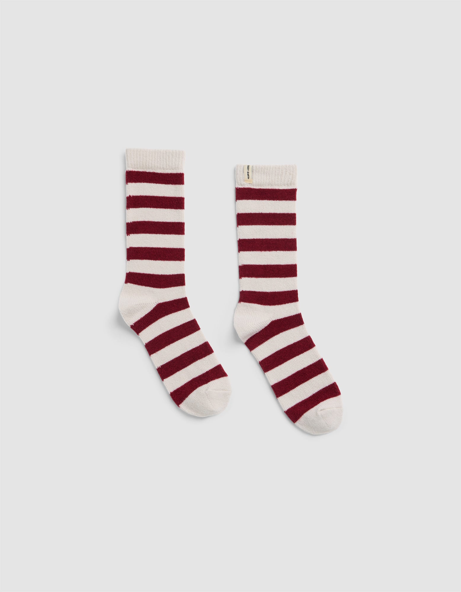 The Plush Modern Crew Sock by Cozy Earth, featuring horizontal maroon and white stripes, is shown crew-length and displayed flat on a light gray background.