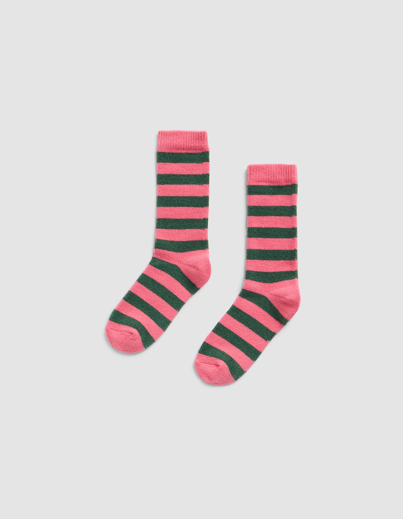 The Striped Plush Lounge Sock by Cozy Earth features horizontal pink and dark green stripes with matching pink heels, toes, and cuffs, displayed on a plain light gray background.