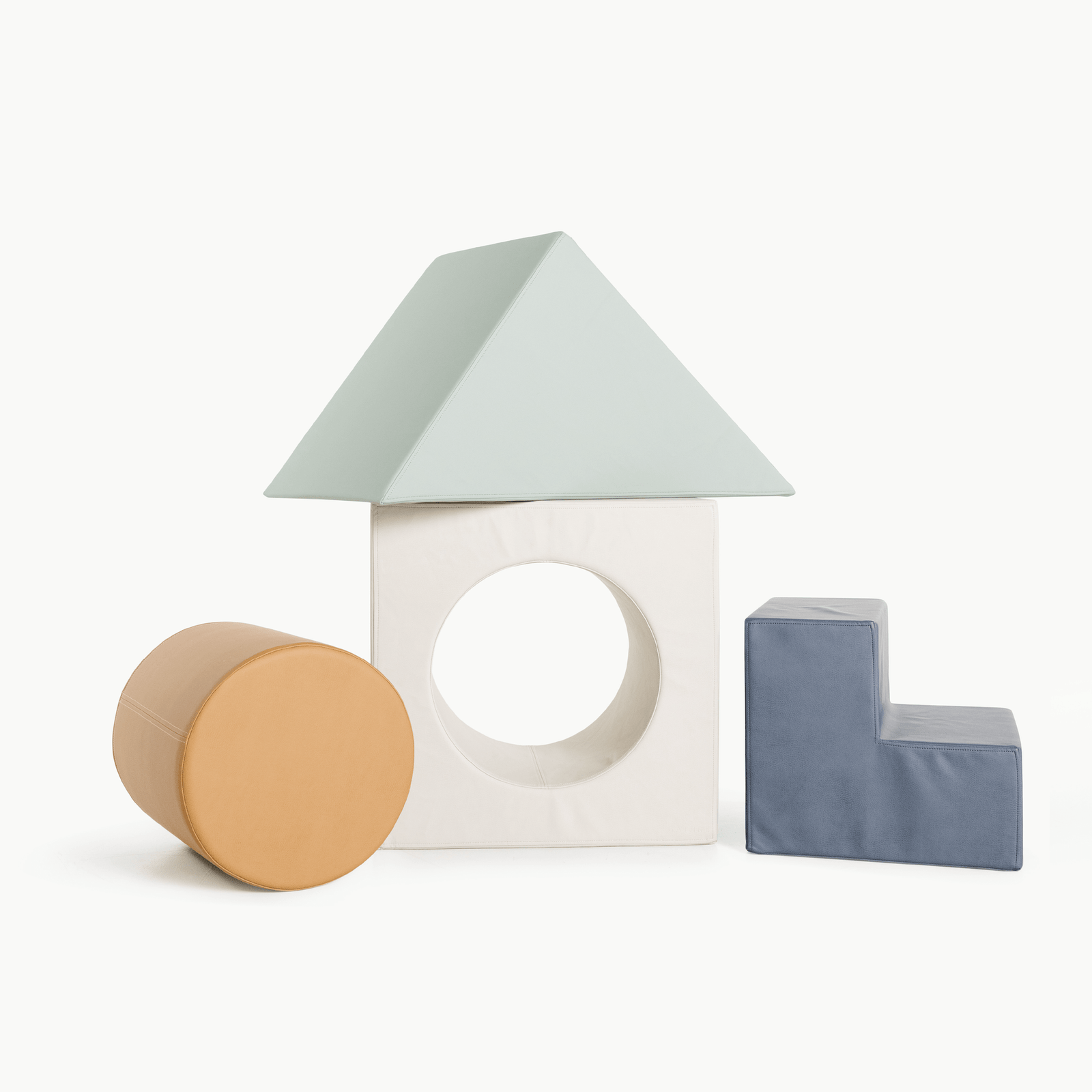 The Gathre Wholesale Block Playset in Nightfall features four foam blocks—a triangle roof, square with circular hole, cylinder, and L-shape—arranged like a house against a white background.