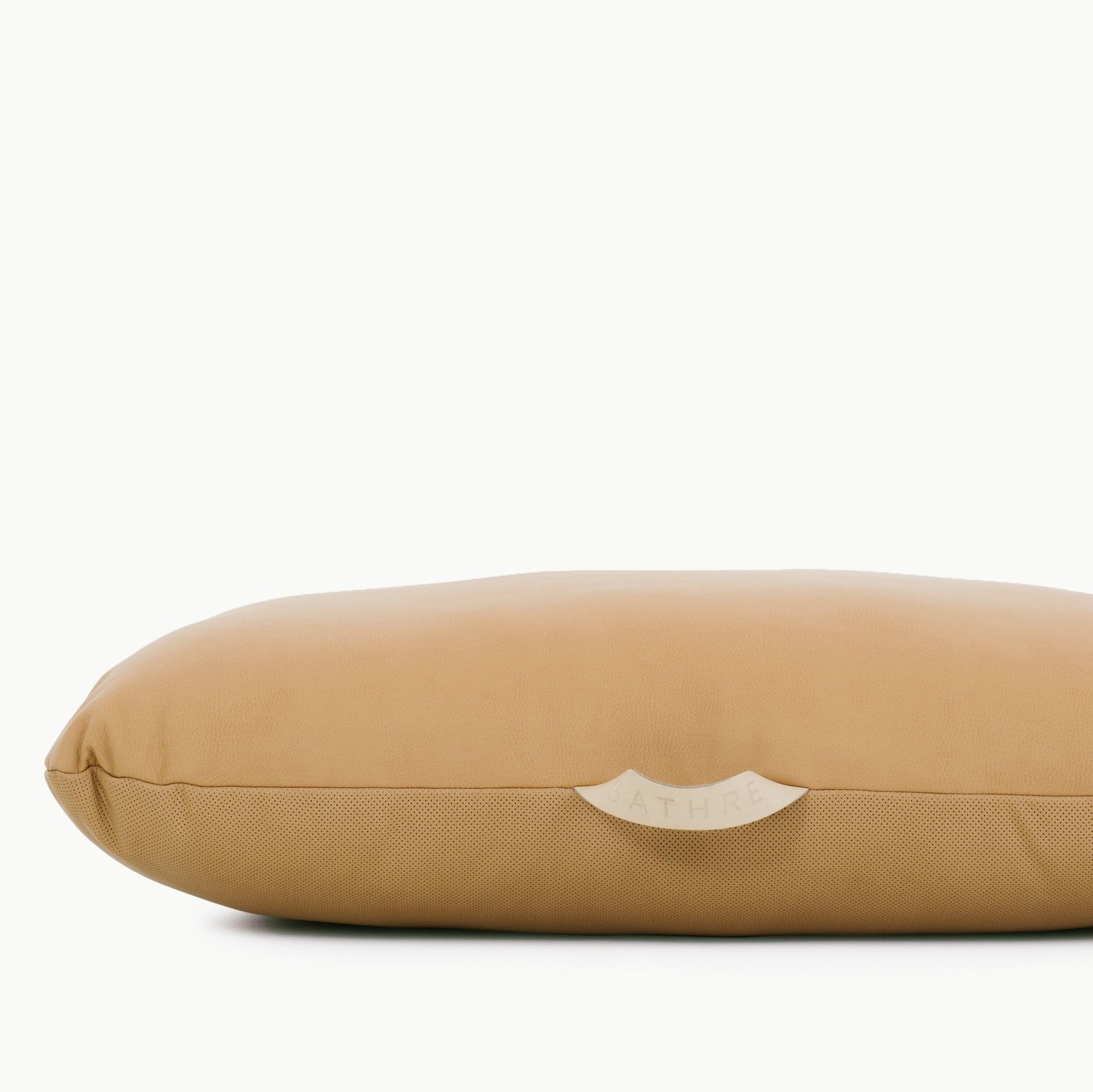 A tan, rectangular Wholesale Floor Cushion by Gathre with a smooth surface and a small white brand tag at the center, photographed against a plain white background.