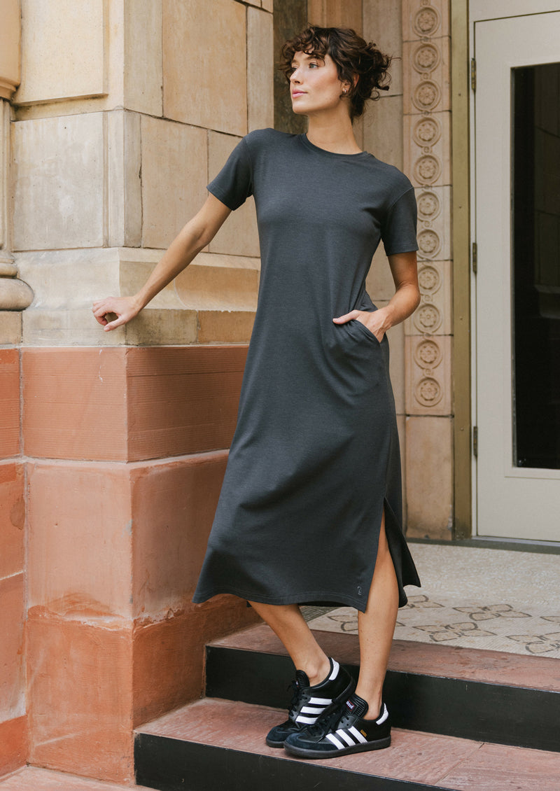 Woman wearing a gray Cozy Earth Brushed Bamboo dress standing on steps outside a building.