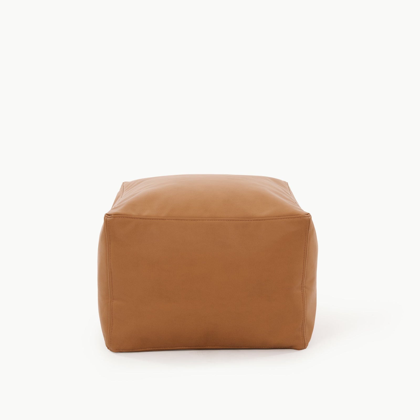 The Gathre Wholesale Pouf is a square, tan leather ottoman with smooth surfaces and visible stitching, shown against a plain white background.