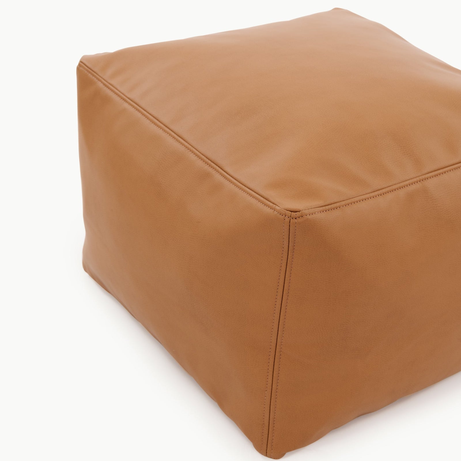 The Gathre Wholesale Pouf is a brown, leather, cube-shaped ottoman featuring visible edge stitching, shown against a white background.