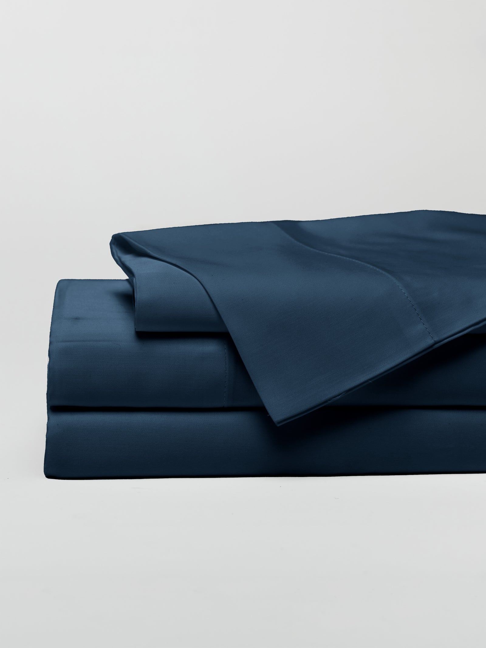 Navy sheet set folded with a white background 