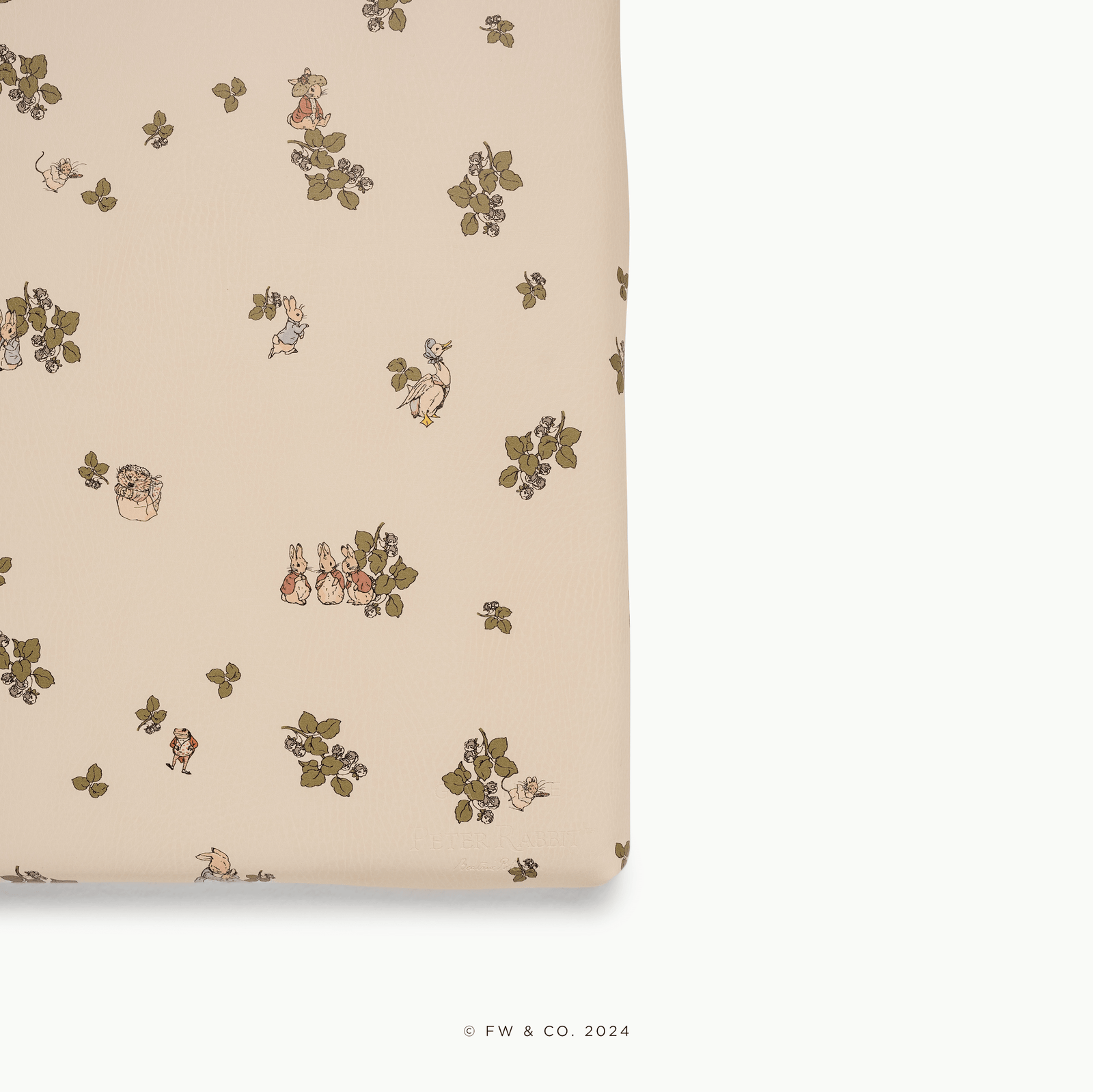The Wholesale Padded Changing Mat by Gathre features a beige fabric adorned with whimsical small animals, leaves, and berries. The mat’s edge displays a white background on the right and bottom sides.