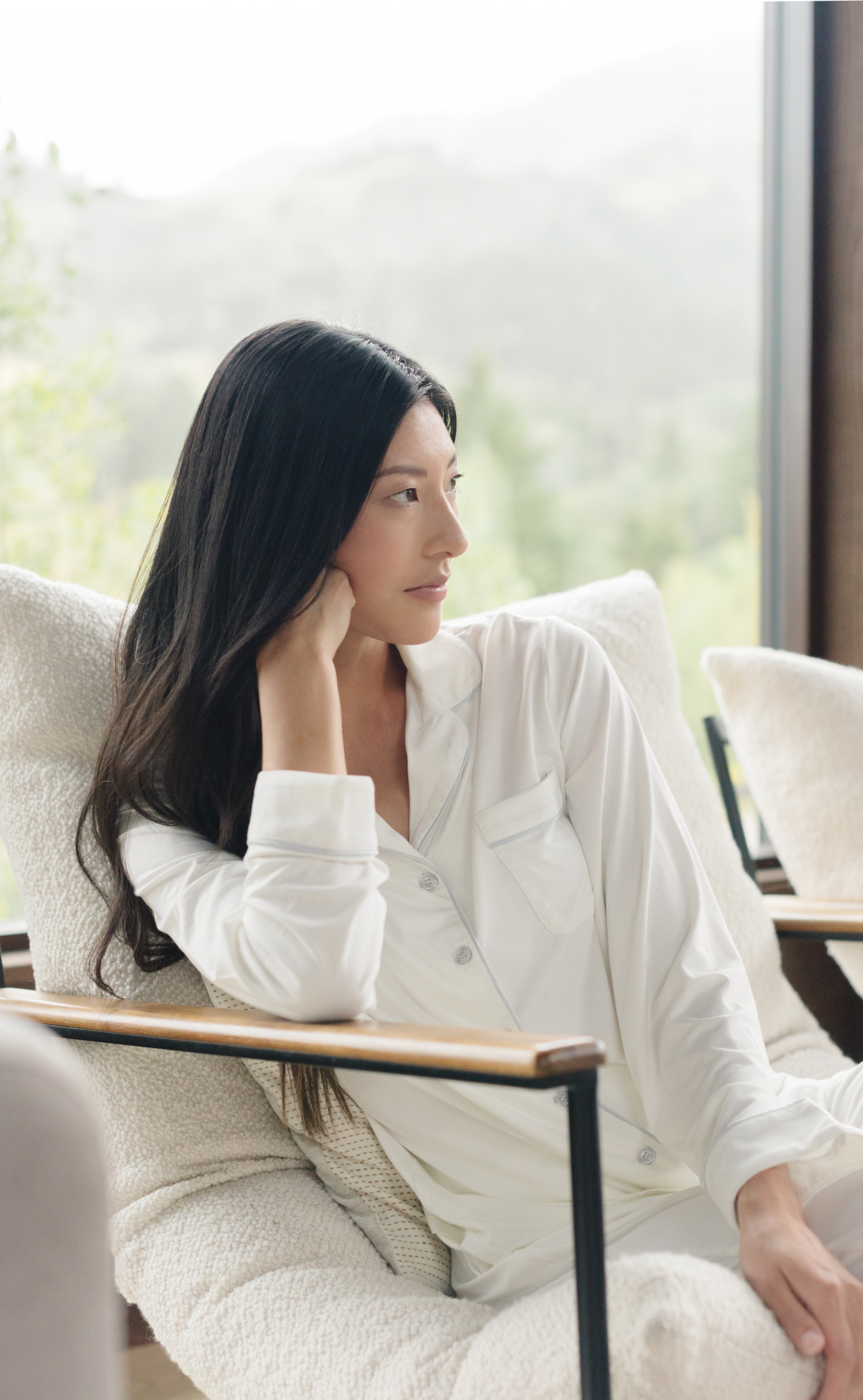 Woman in white pajamas facing right