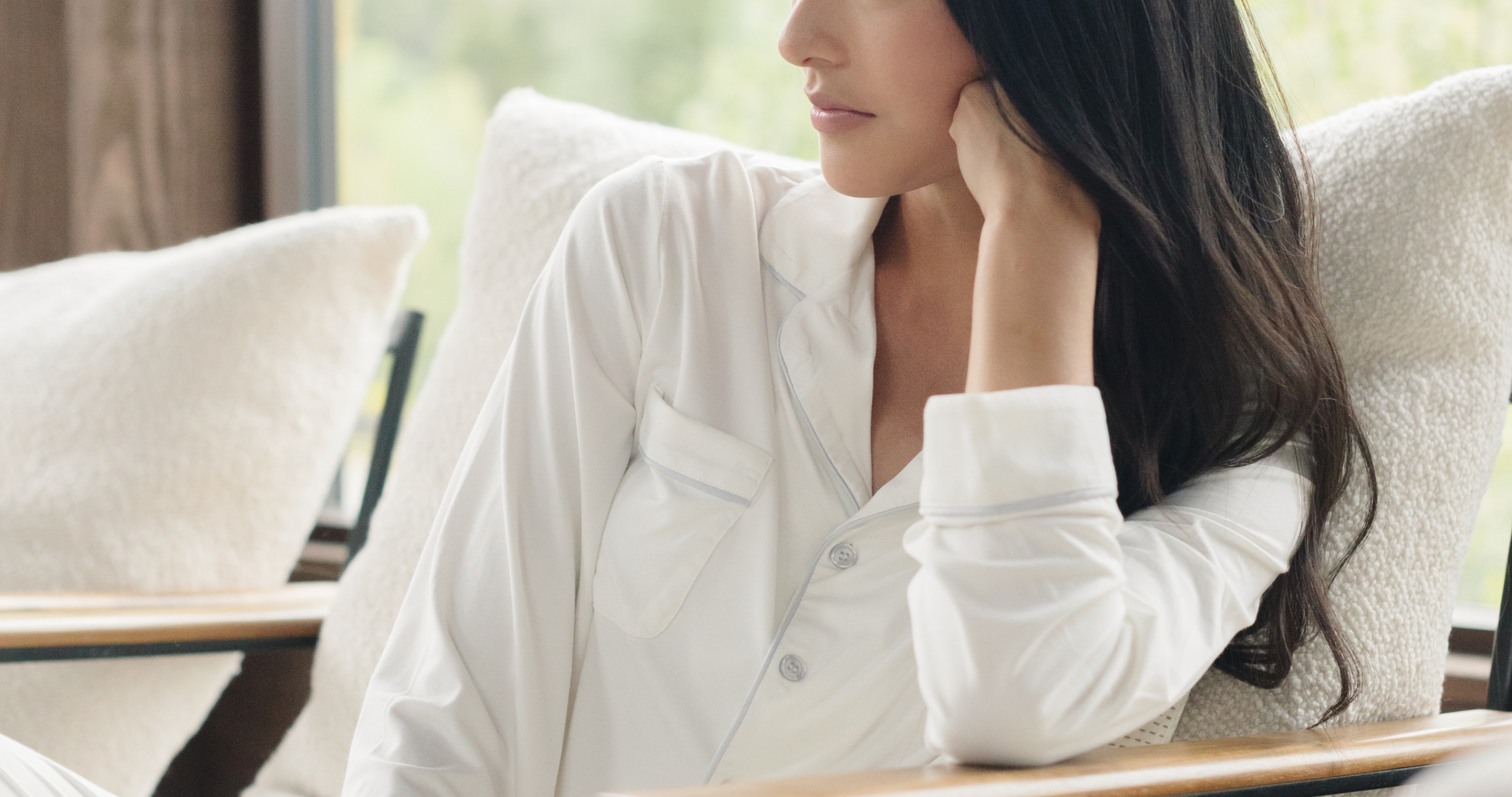 Woman in white pajamas facing left