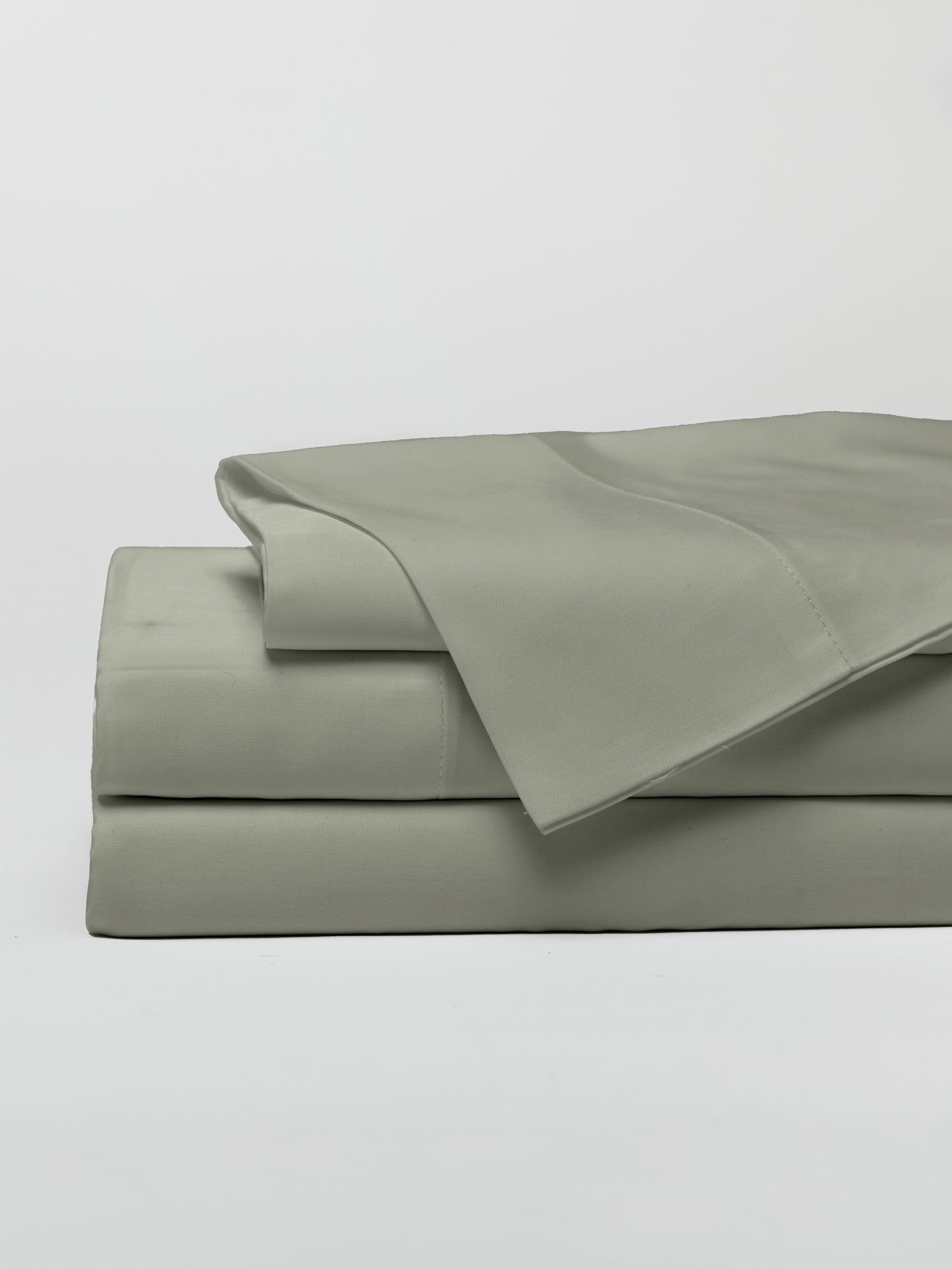 Sage sheet set folded with a white background 