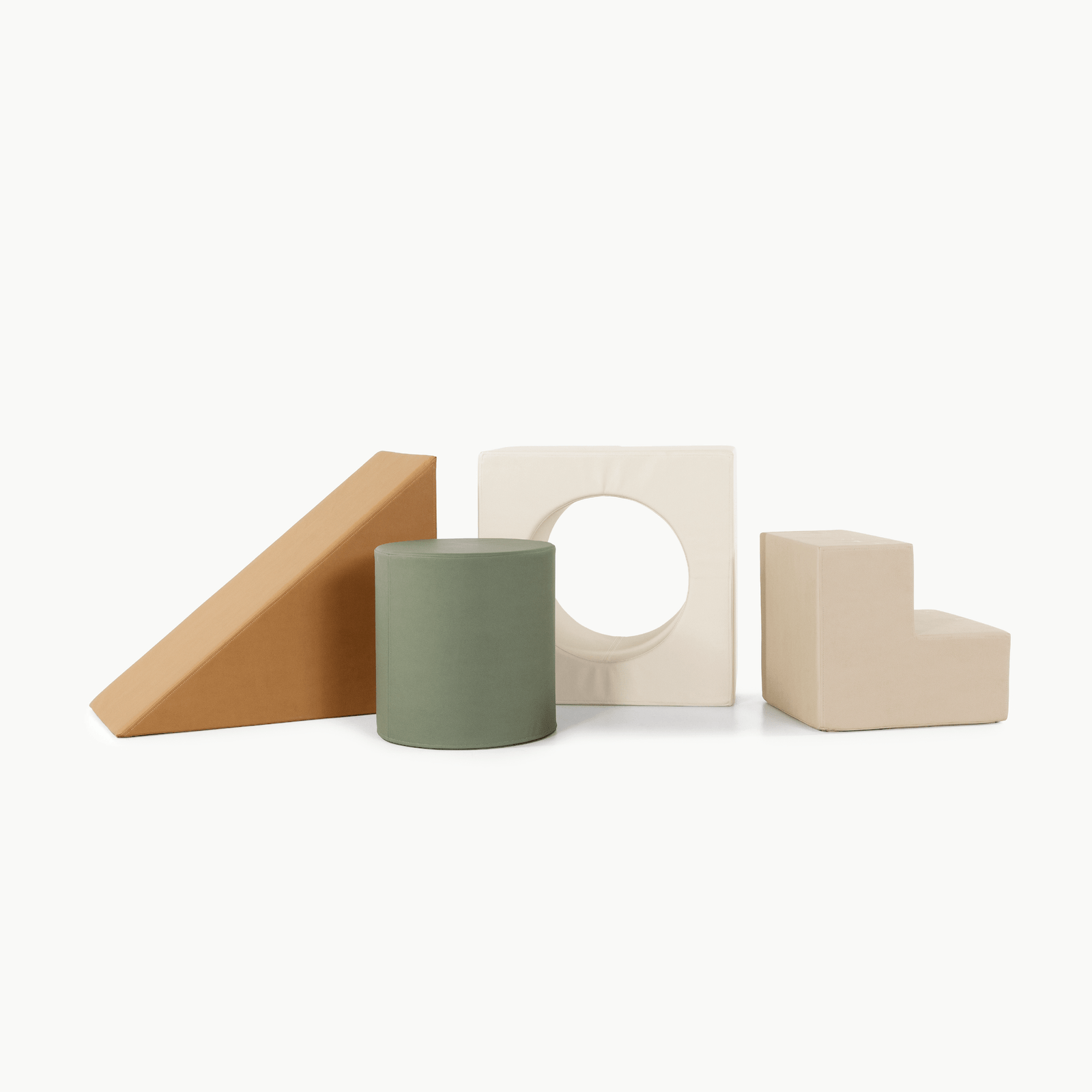 The Gathre Wholesale Block Playset in Thyme features four foam shapes—a wedge, cylinder, square with circular cut-out, and L-shaped block—arranged in a row on a white background.