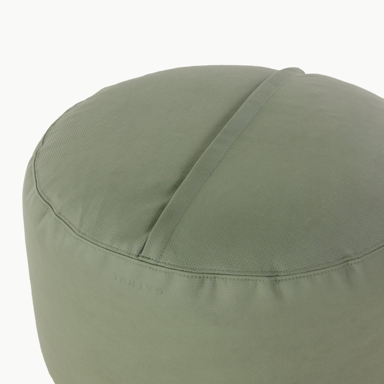 The Gathre Wholesale Pouf is a round, sage green fabric pouf featuring a subtle seam and a discreet logo near the bottom, displayed on a plain white background.